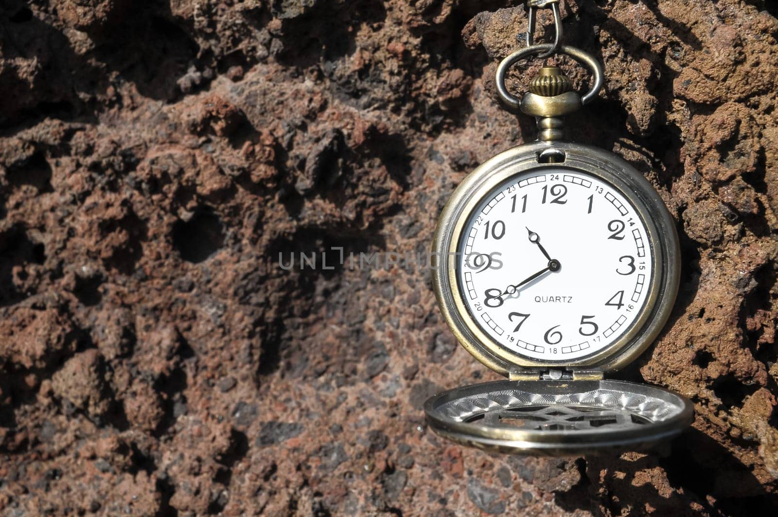 Time Concept Classic Vintage Pocket Clock on the Volcanic Rocks