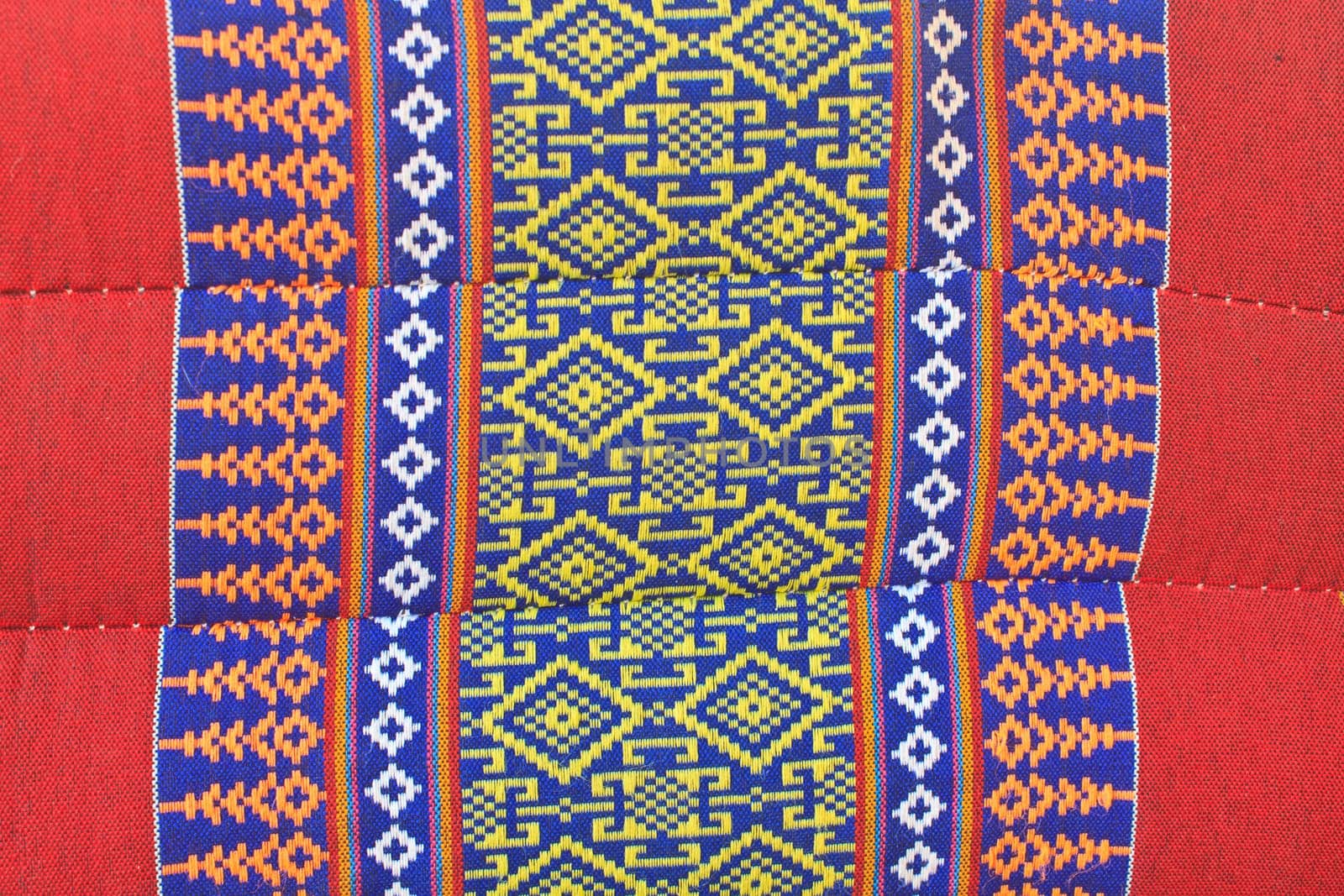 Thai Esan traditional pillows have a specific shape like cube and contain the pure cotton inside. The pillow surface has a specific weaving pattern and gaudy color. Handcraft art.