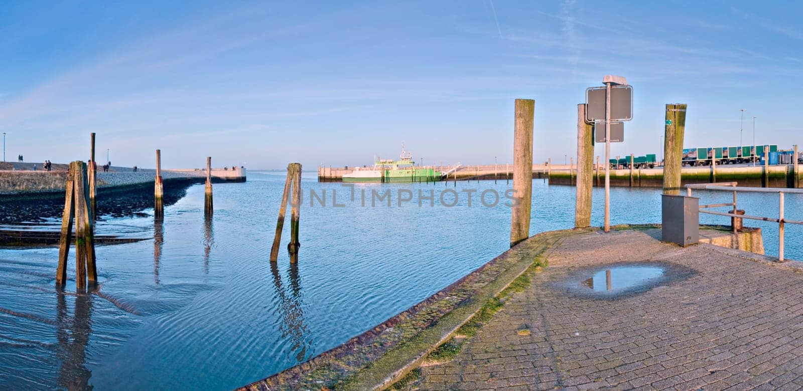 Panorama at the Neuharlingersiel harbour exit in autumn with blue skies