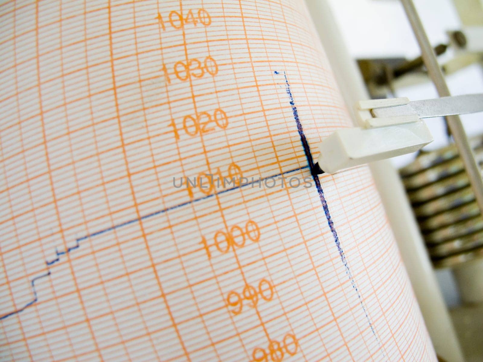 Close-up of a weather writer with blue felt-tip pen on chart paper and mechanical rods