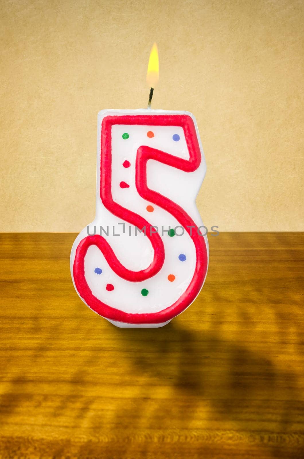 Burning birthday candle number 5