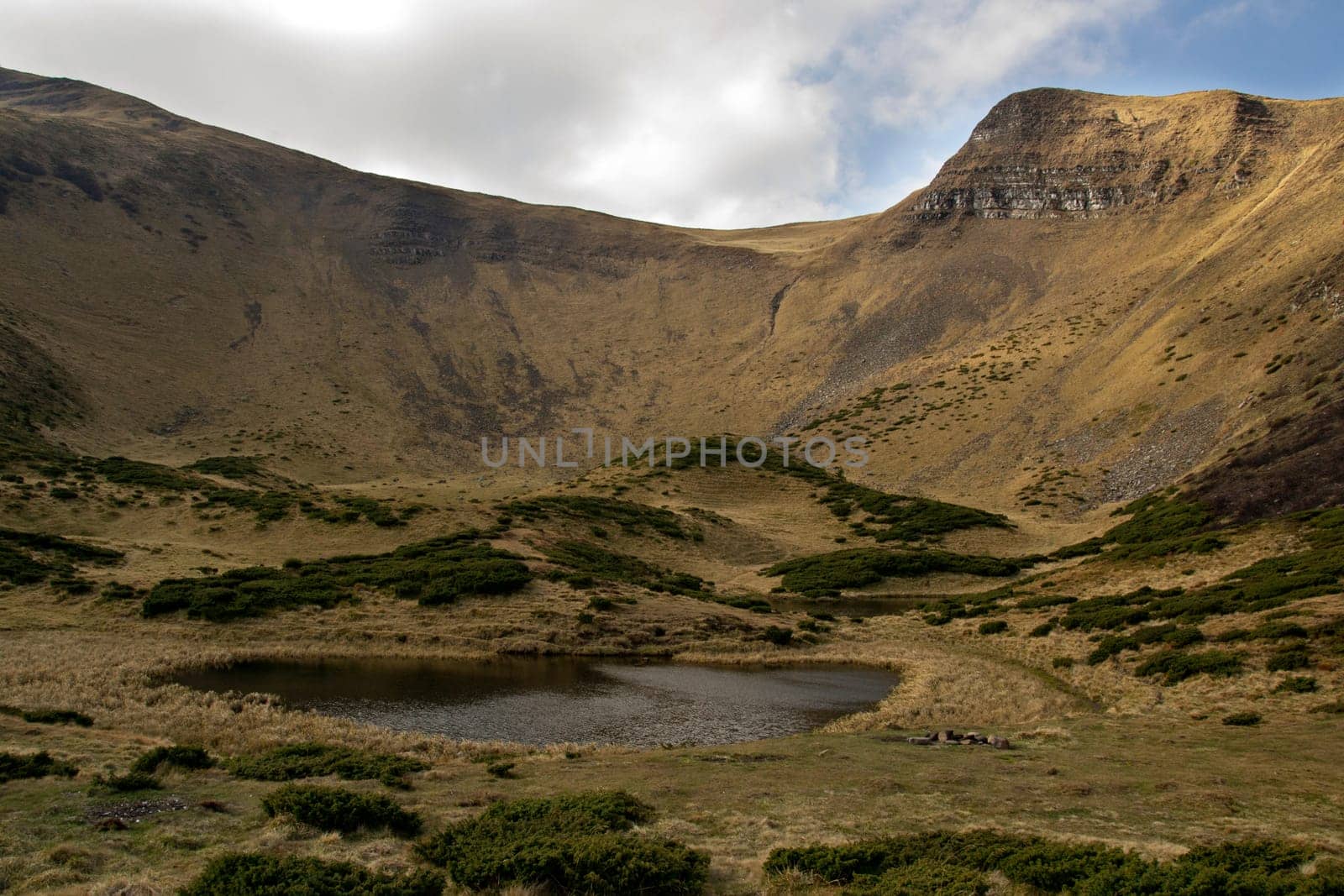 Oval lake at the foot of the mountain