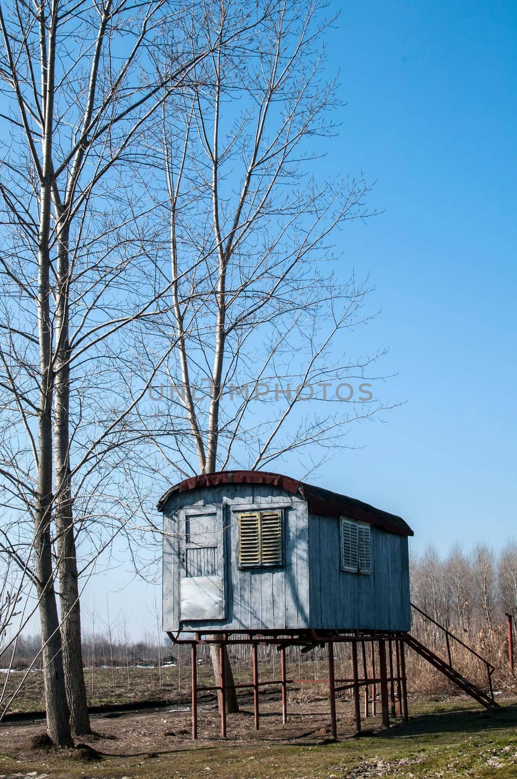Stilt fisherman bungalow on iron piles in sunny winter day