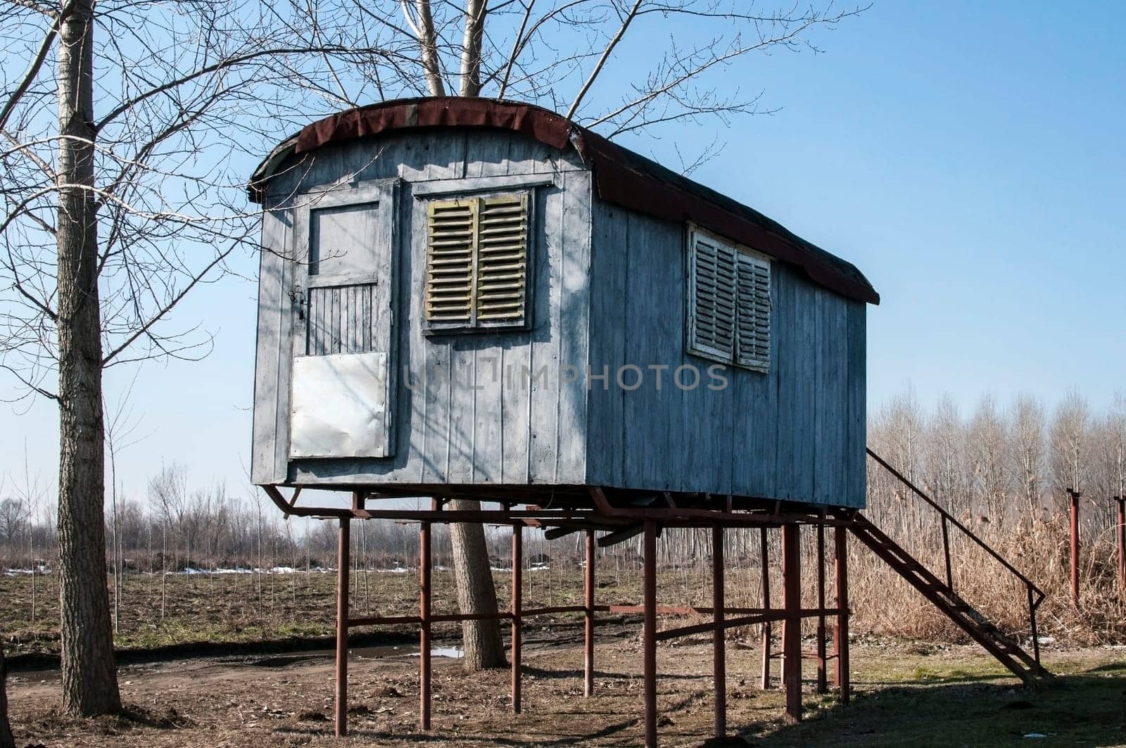 Stilt fisherman bungalow on iron piles in sunny winter day