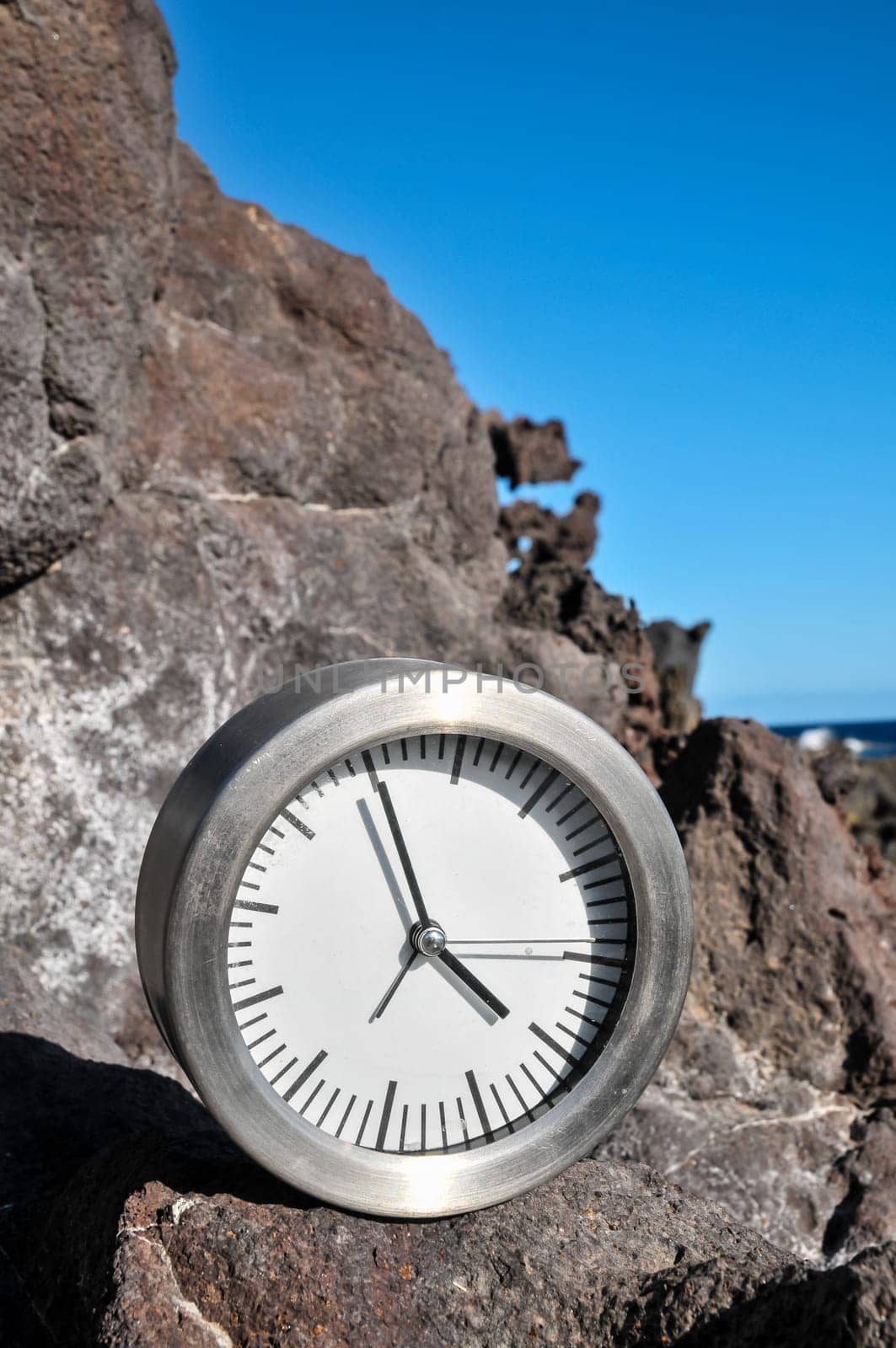 Time Concept Alarm Clock on the Volcanic Rocks