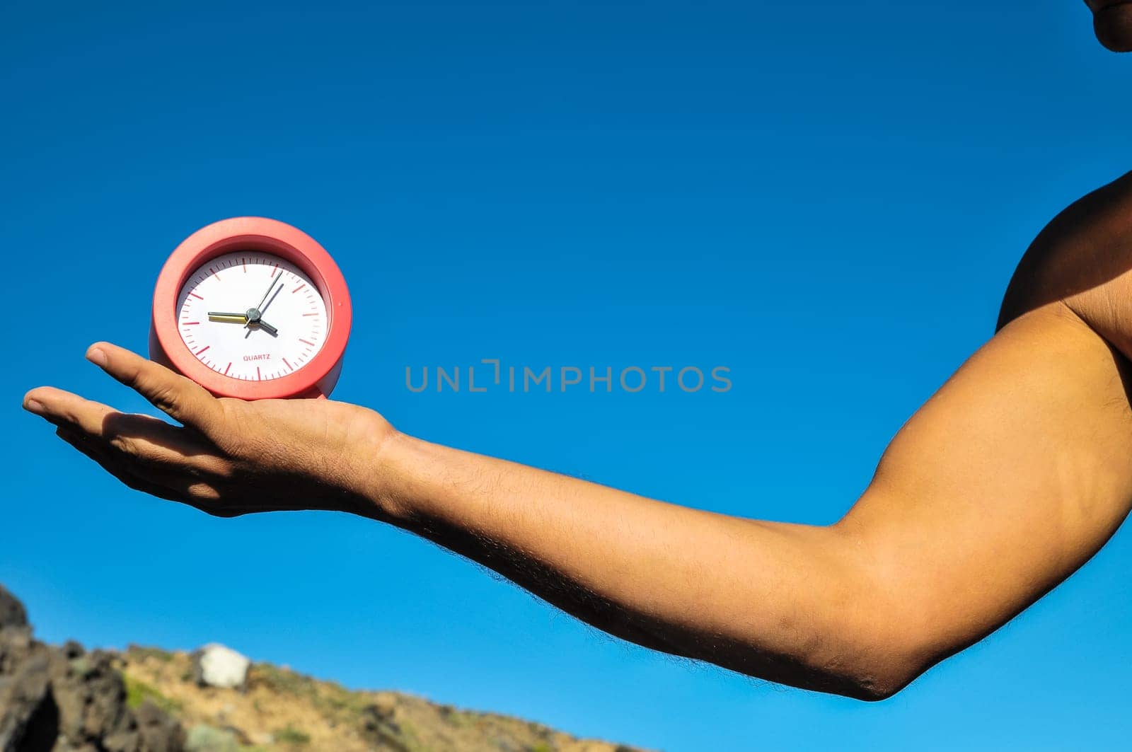 Time Concept White Sand Hourglass on the Volcanic Rocks