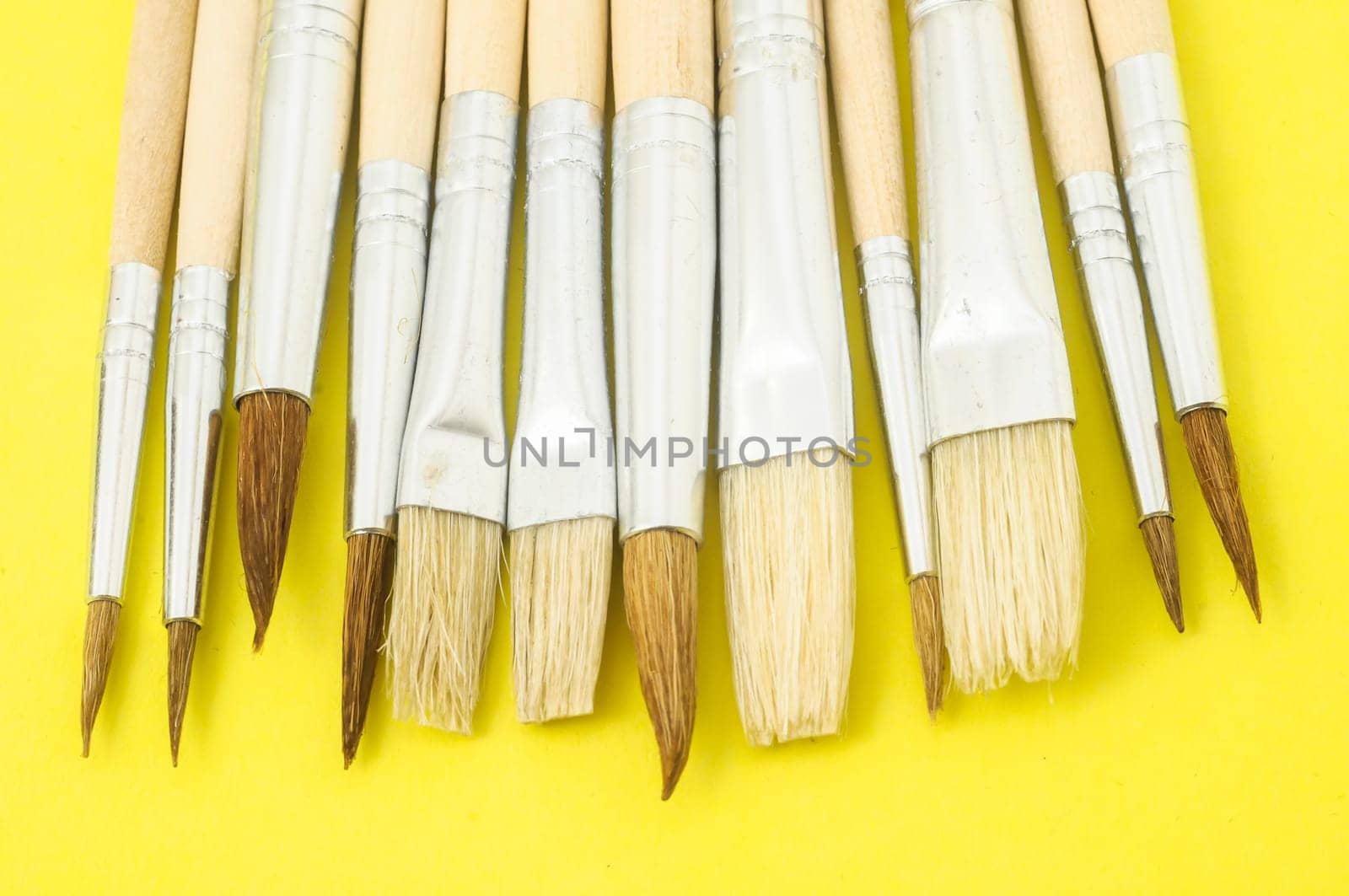 New Wooden Different Paintbrush Set Texture over a Colored Background