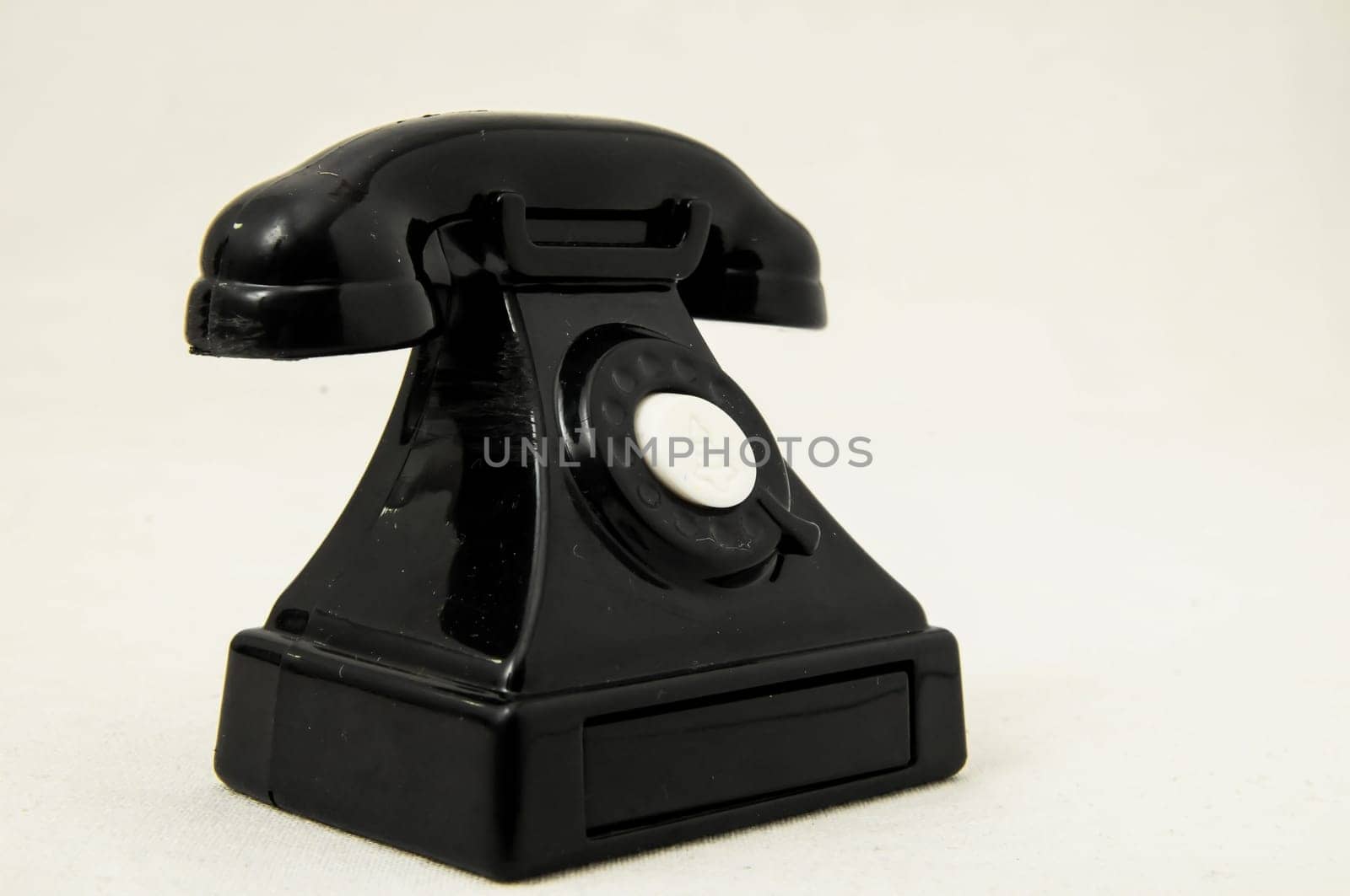 Vintage Old Telephone Plastic Black Toy on a White Background