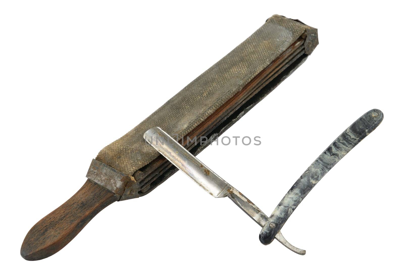 Old (rusty) straight razor with strop isolated on white.