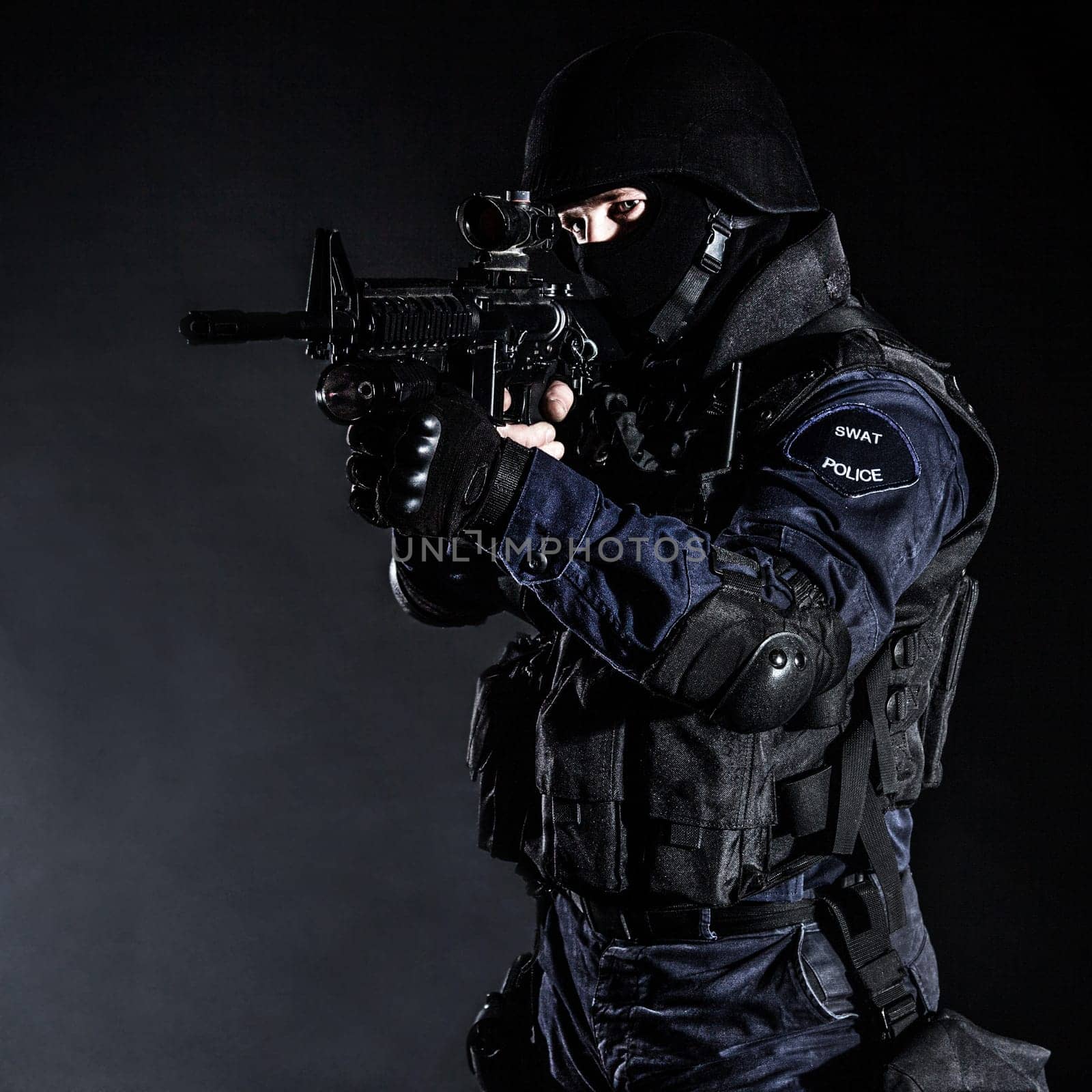 Special weapons and tactics (SWAT) team officer on black background