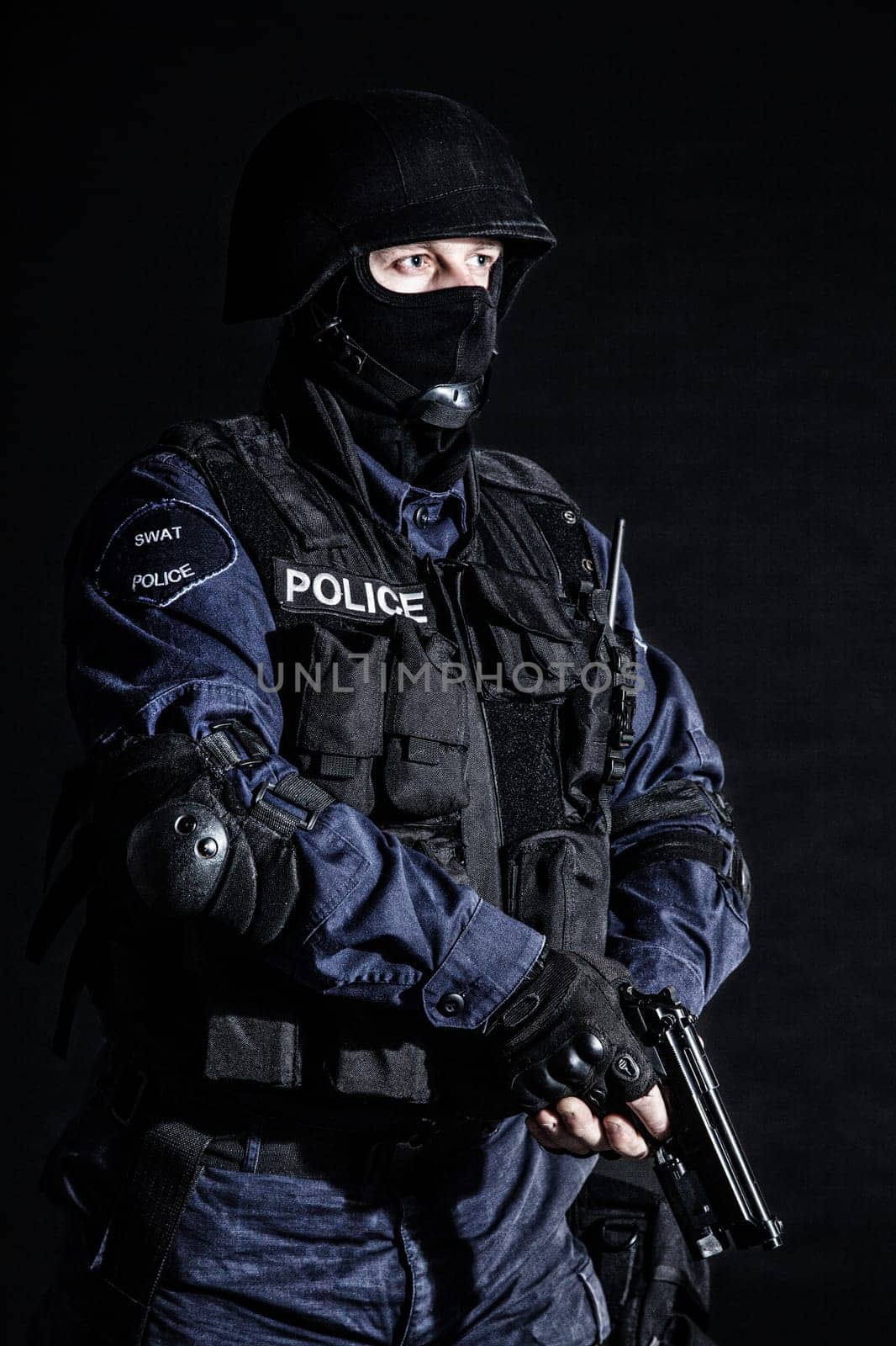 Special weapons and tactics (SWAT) team officer on black background
