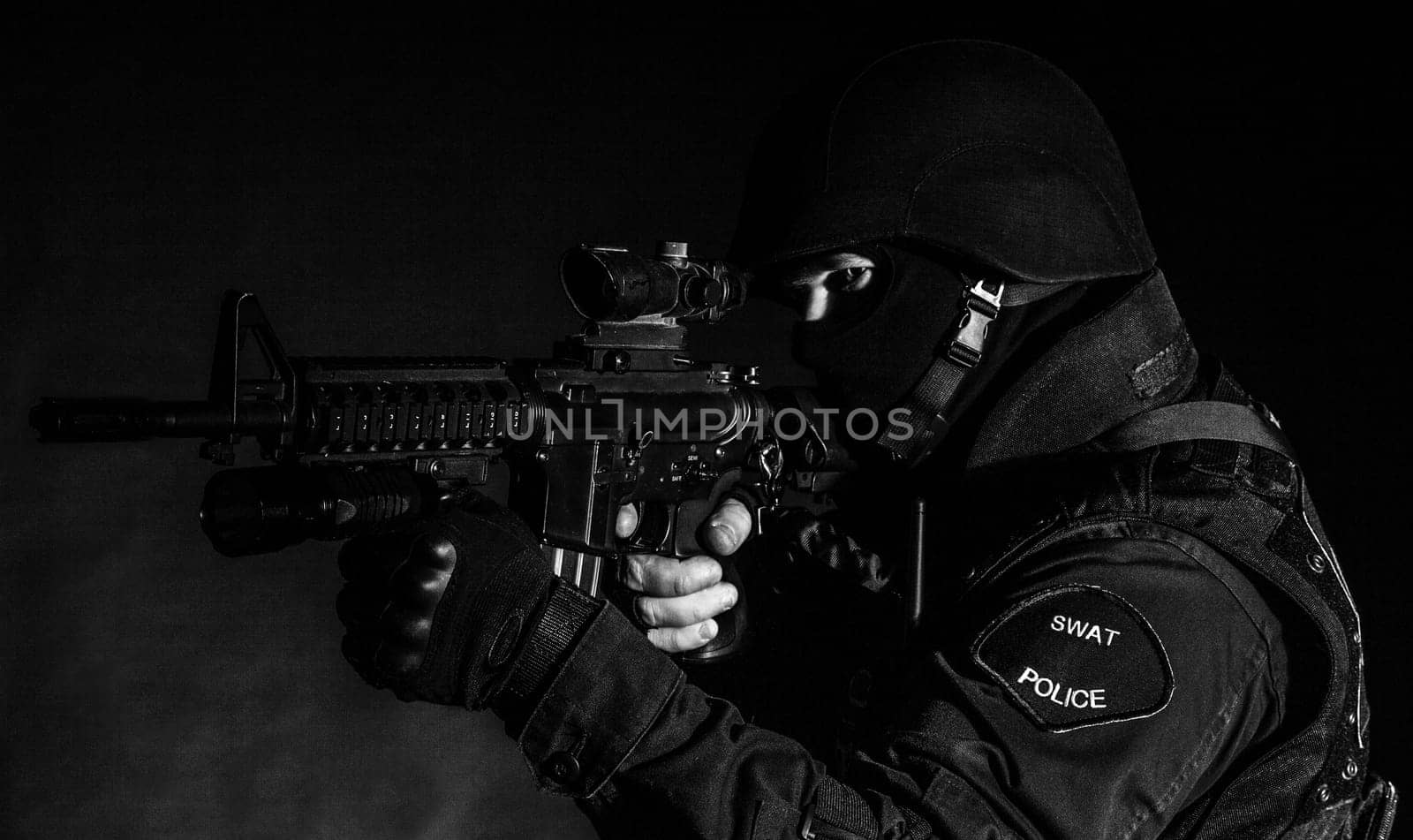 Special weapons and tactics (SWAT) team officer on black background