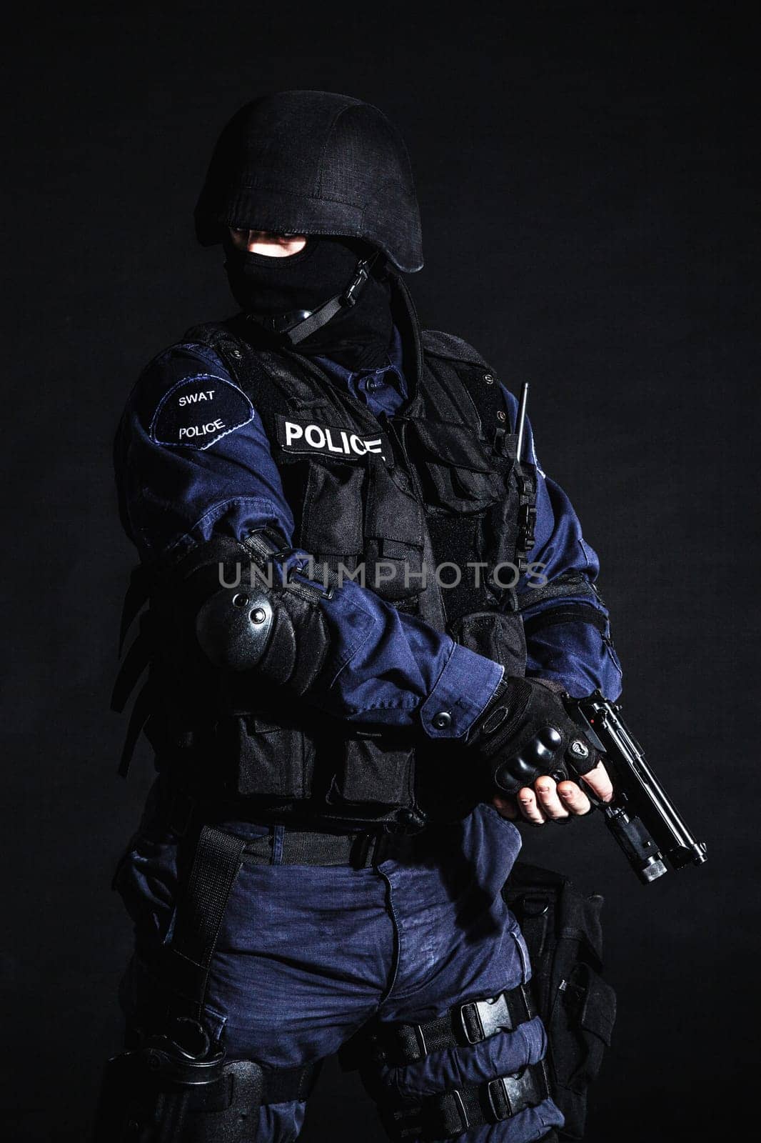 Special weapons and tactics (SWAT) team officer on black background