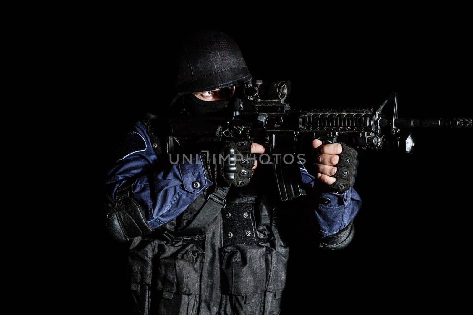 Special weapons and tactics (SWAT) team officer on black background