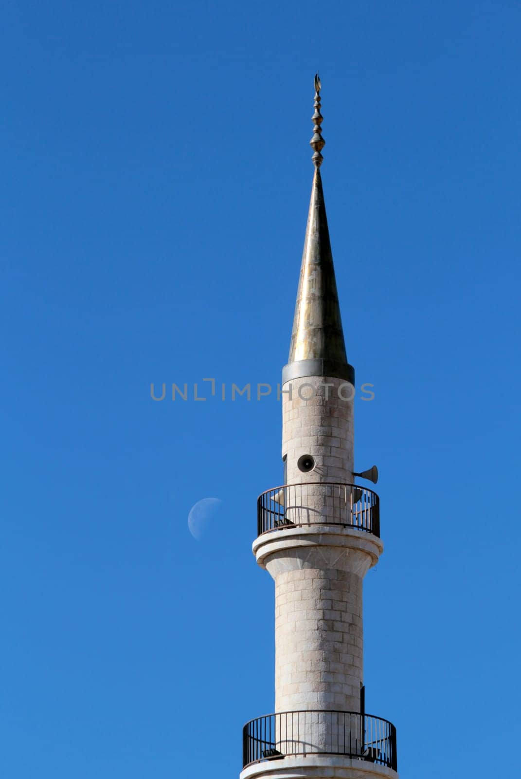 Madaba "jesuscristo"" Mosque minaret in blue sky, moon in the background, Jordan"