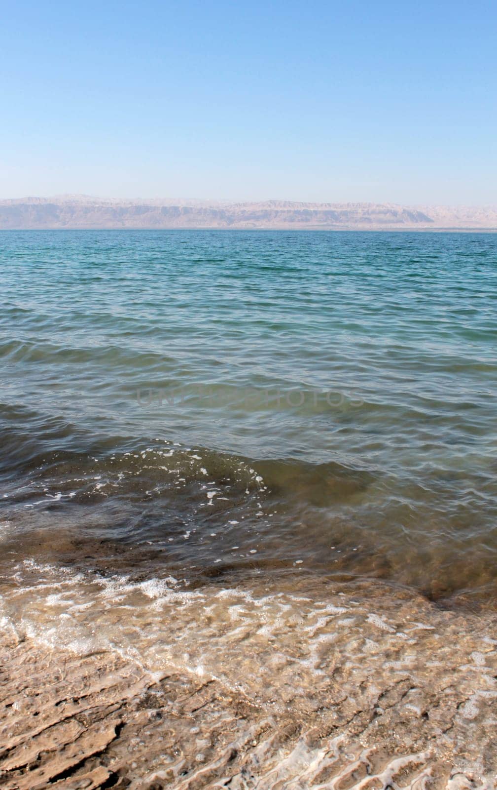 Dead Sea coastline, whit salt crystals and formations in the sand. Jordan