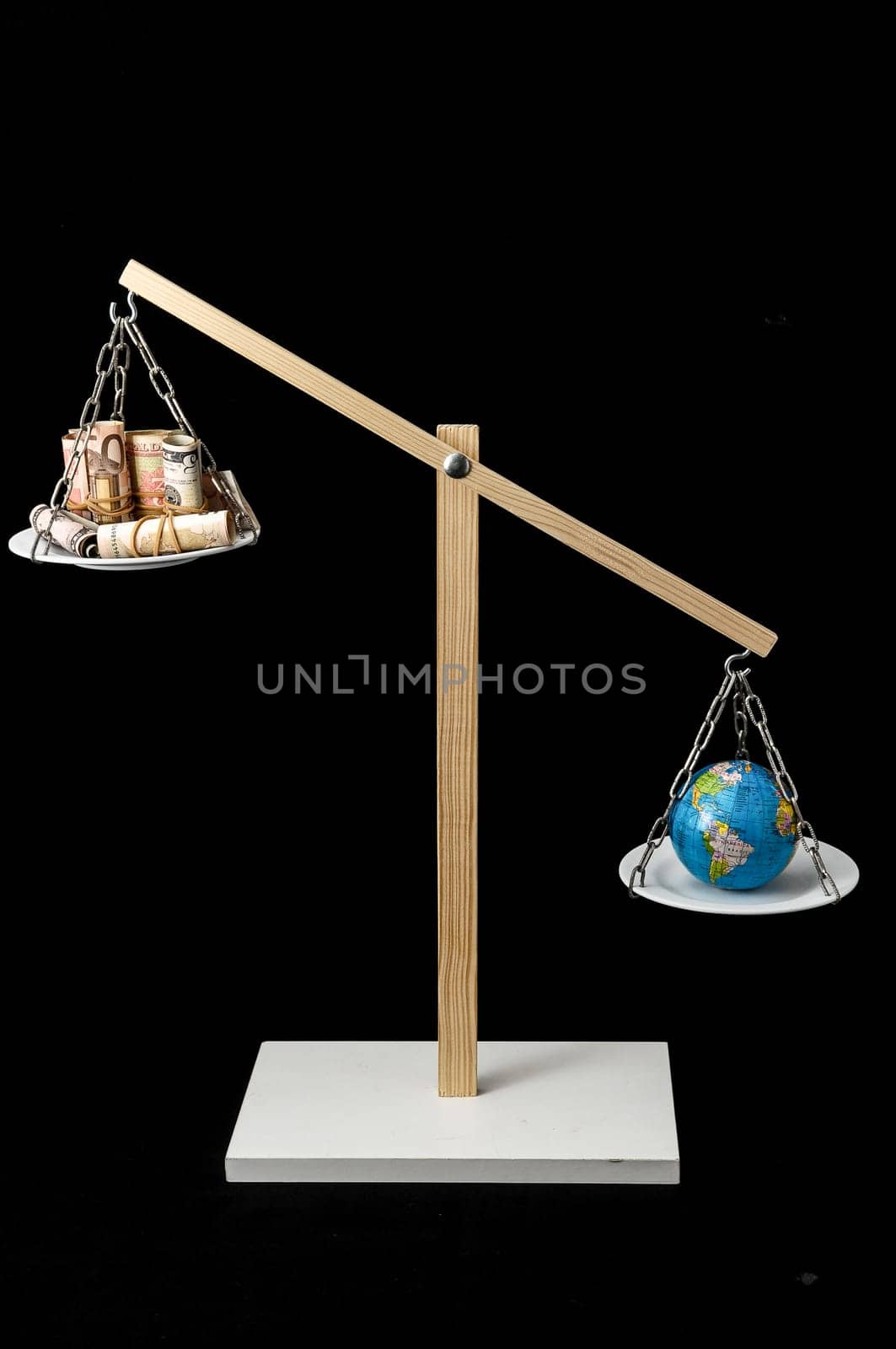Globe Planet Earth and Money on a Two Pan Balance