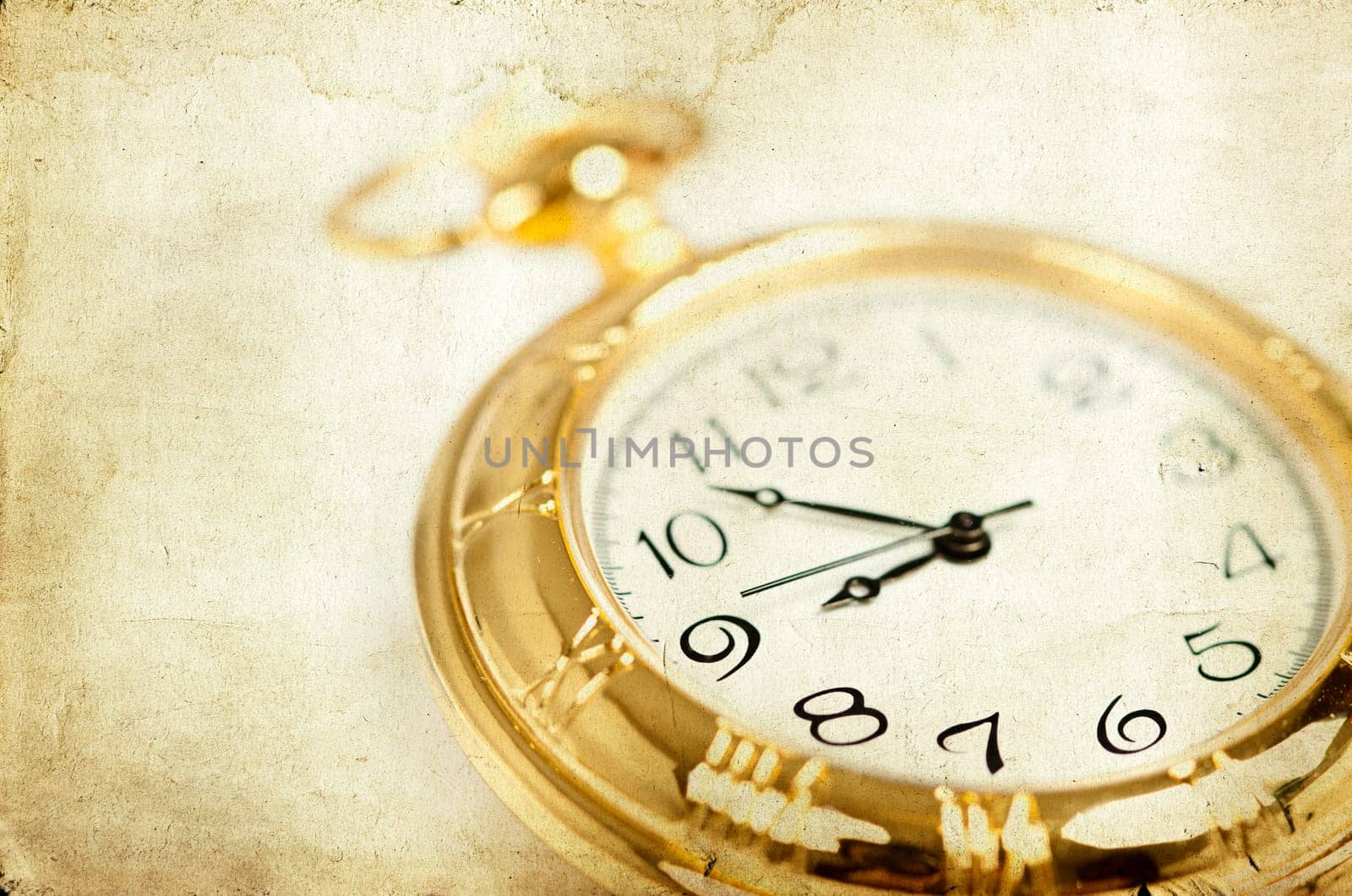 Old styled gold pocket watch on scarlet silk