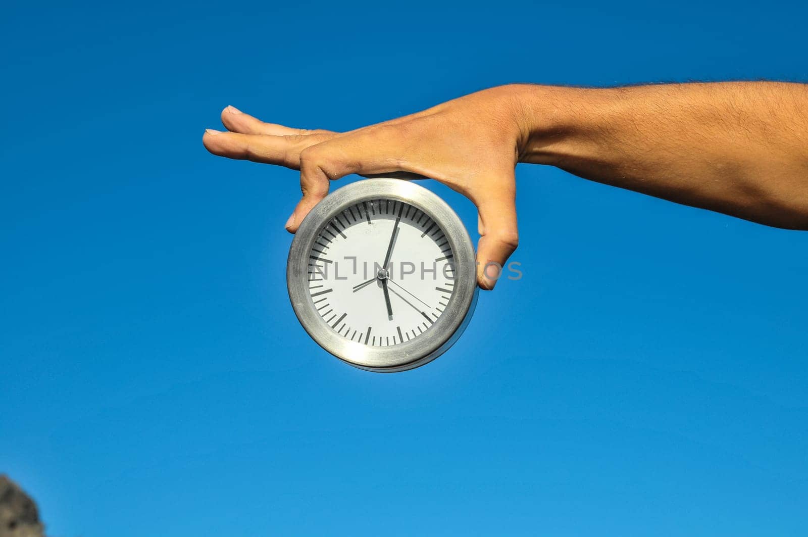 Time Concept White Sand Hourglass on the Volcanic Rocks