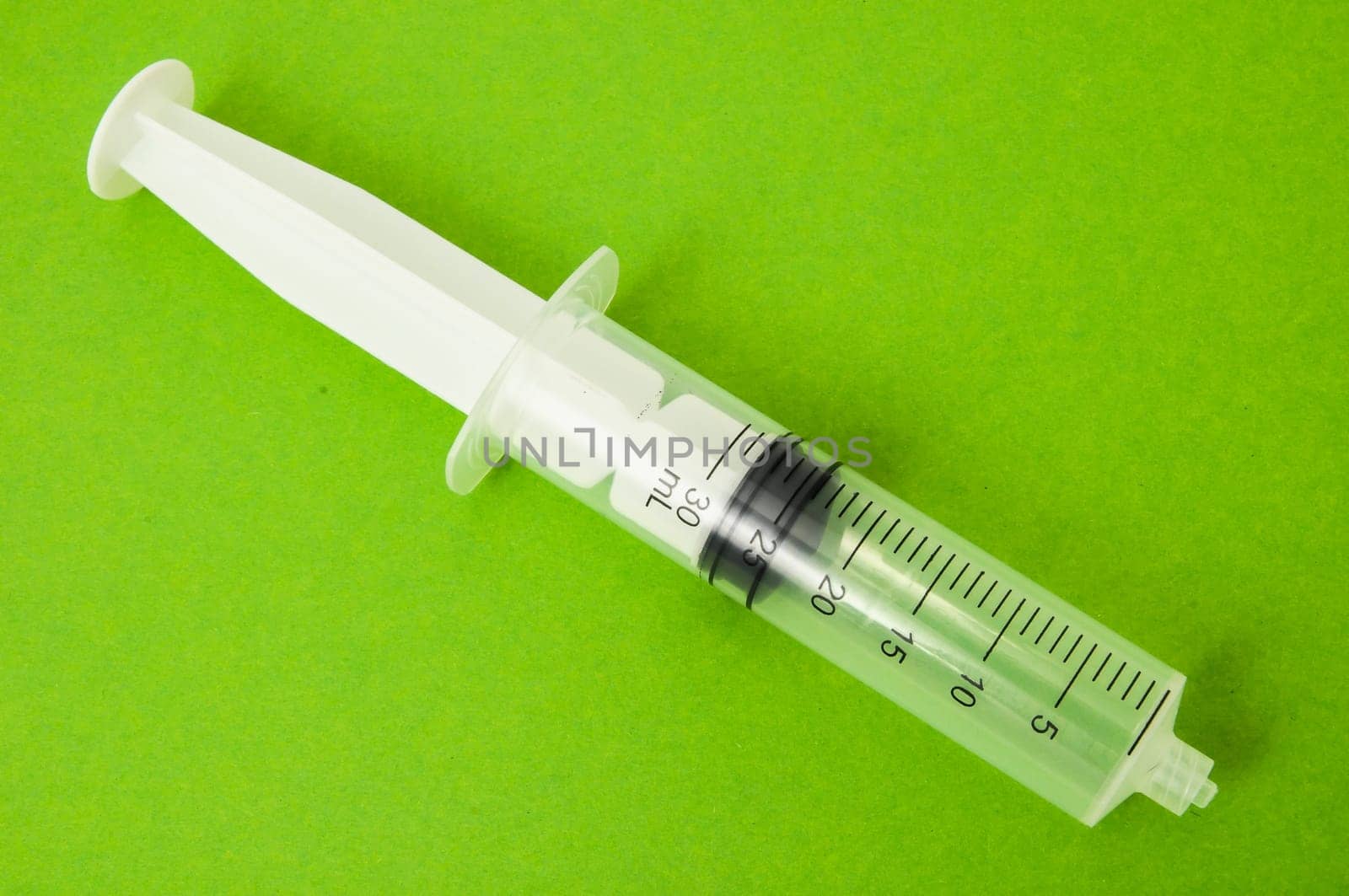 Big Black and White Syringe on a Colored Background