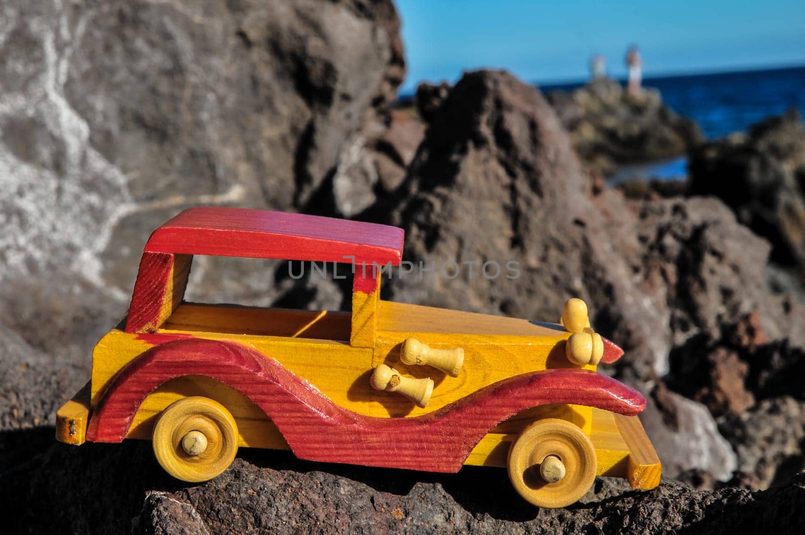Transportation Concept Wooden Toy Car on the Rocks