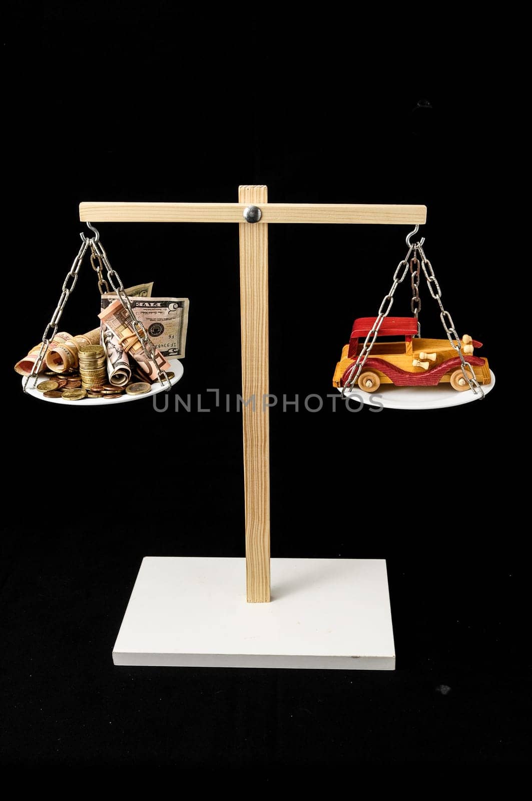 Money and Toy Wooden Car on a Two Pan Balance