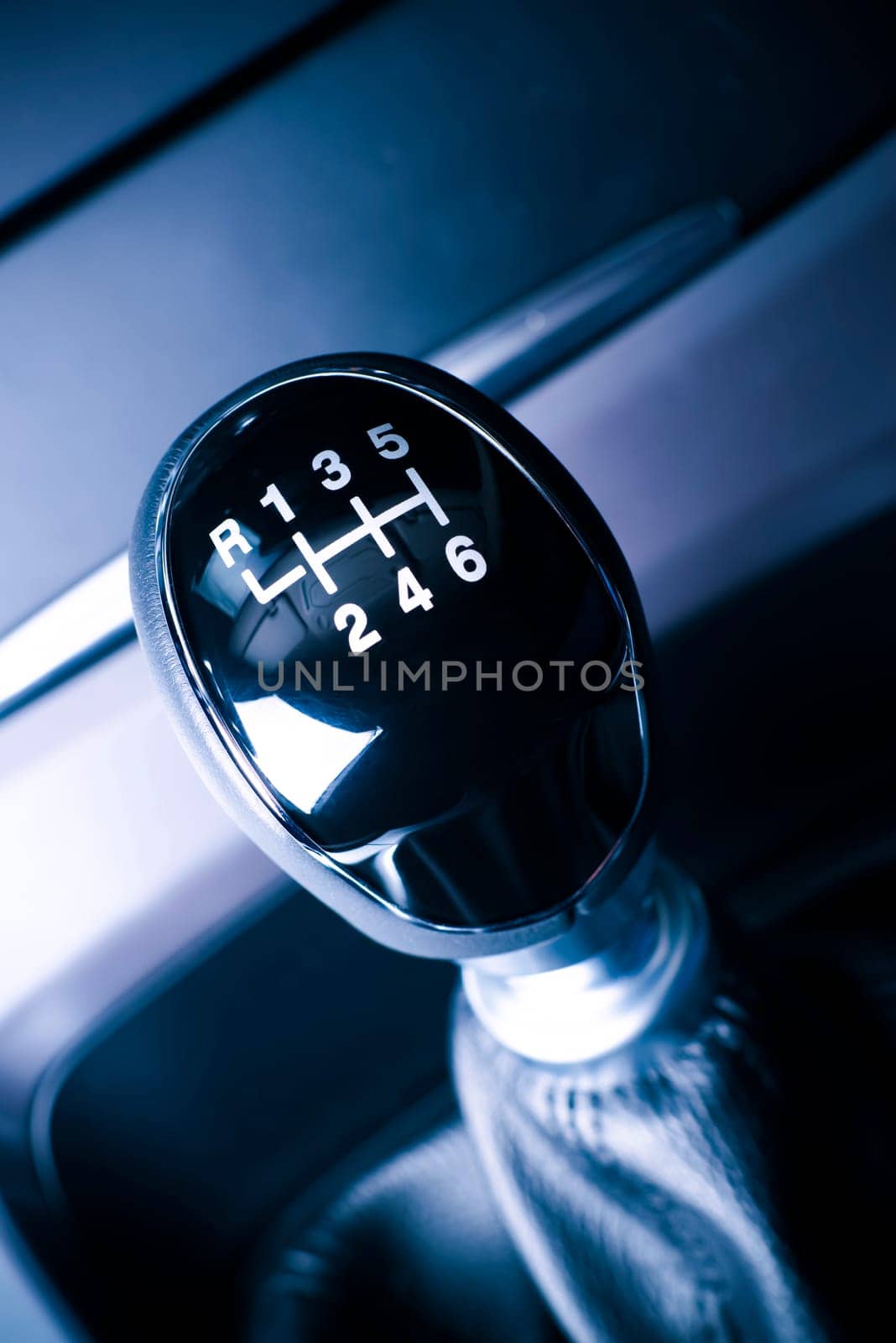 interior of the car,the vehicle with visible lever of manual transmission,with metal chrome elements.
