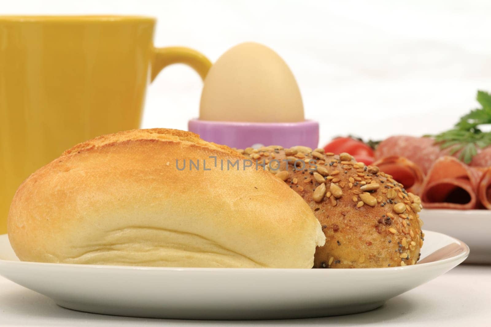 Cut-out of a breakfast table with rolls,cold cuts,egg and coffee cup