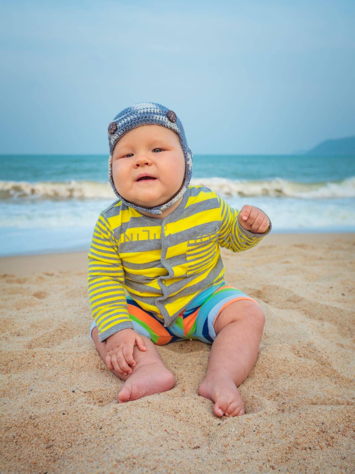 Cute baby sitting on a sand