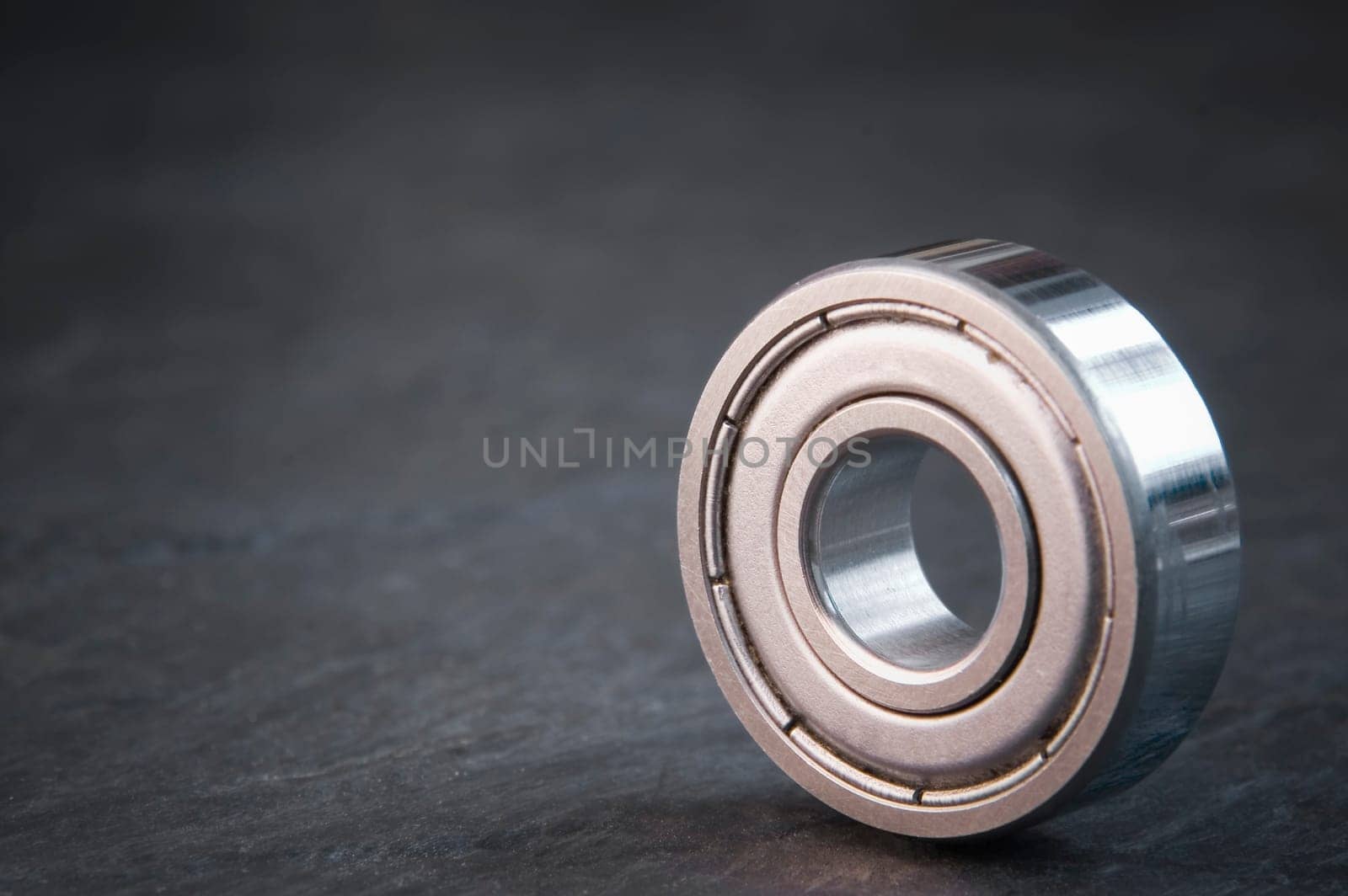 Product holder of a single ball bearing on slate  very shallow depth of field