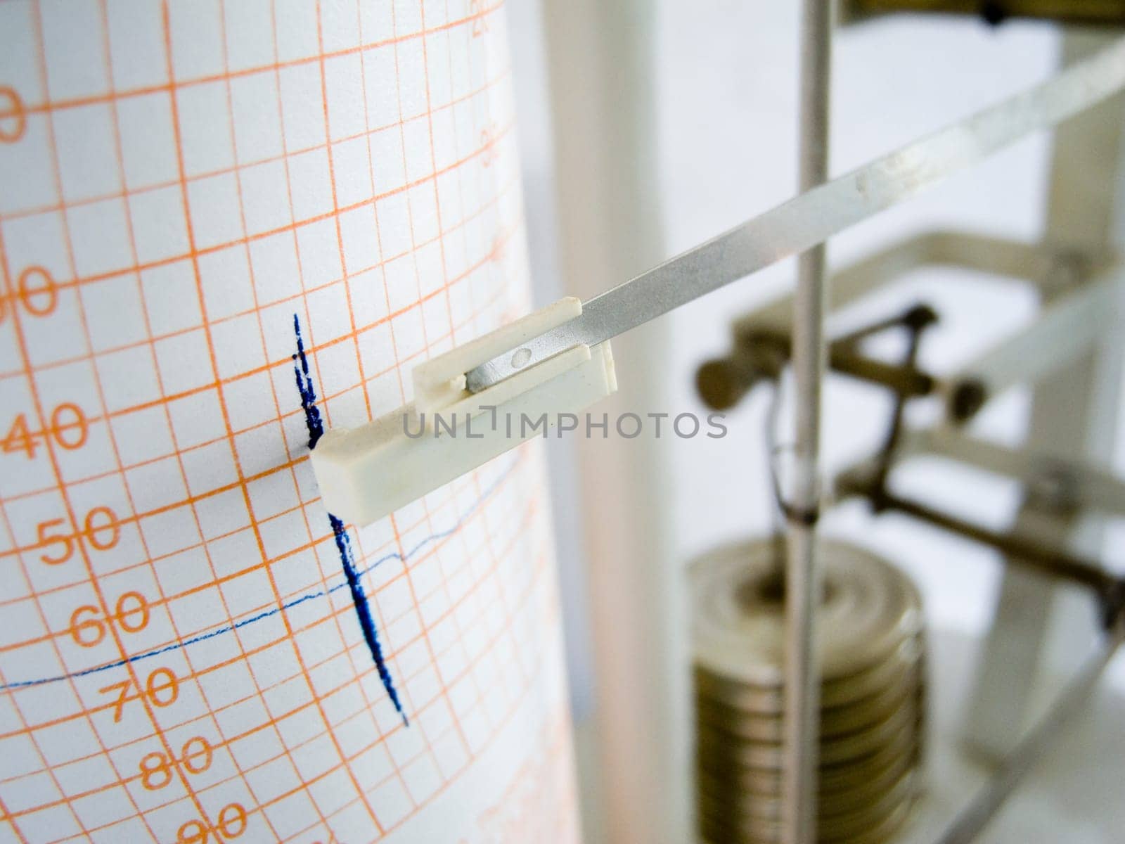 Close-up of a weather writer with blue felt-tip pen on chart paper and mechanical rods
