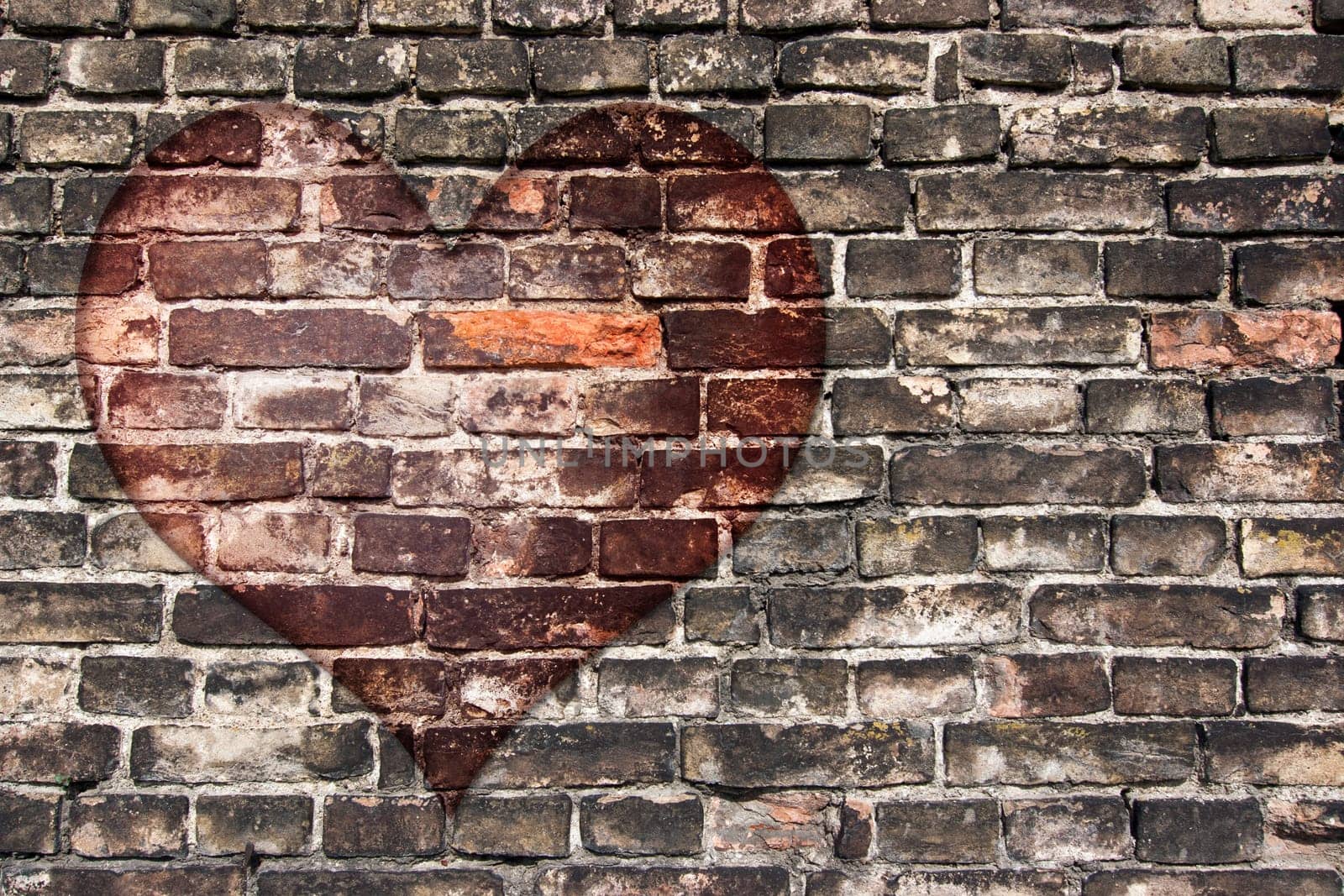 Image of the heart on the old broken brick wall