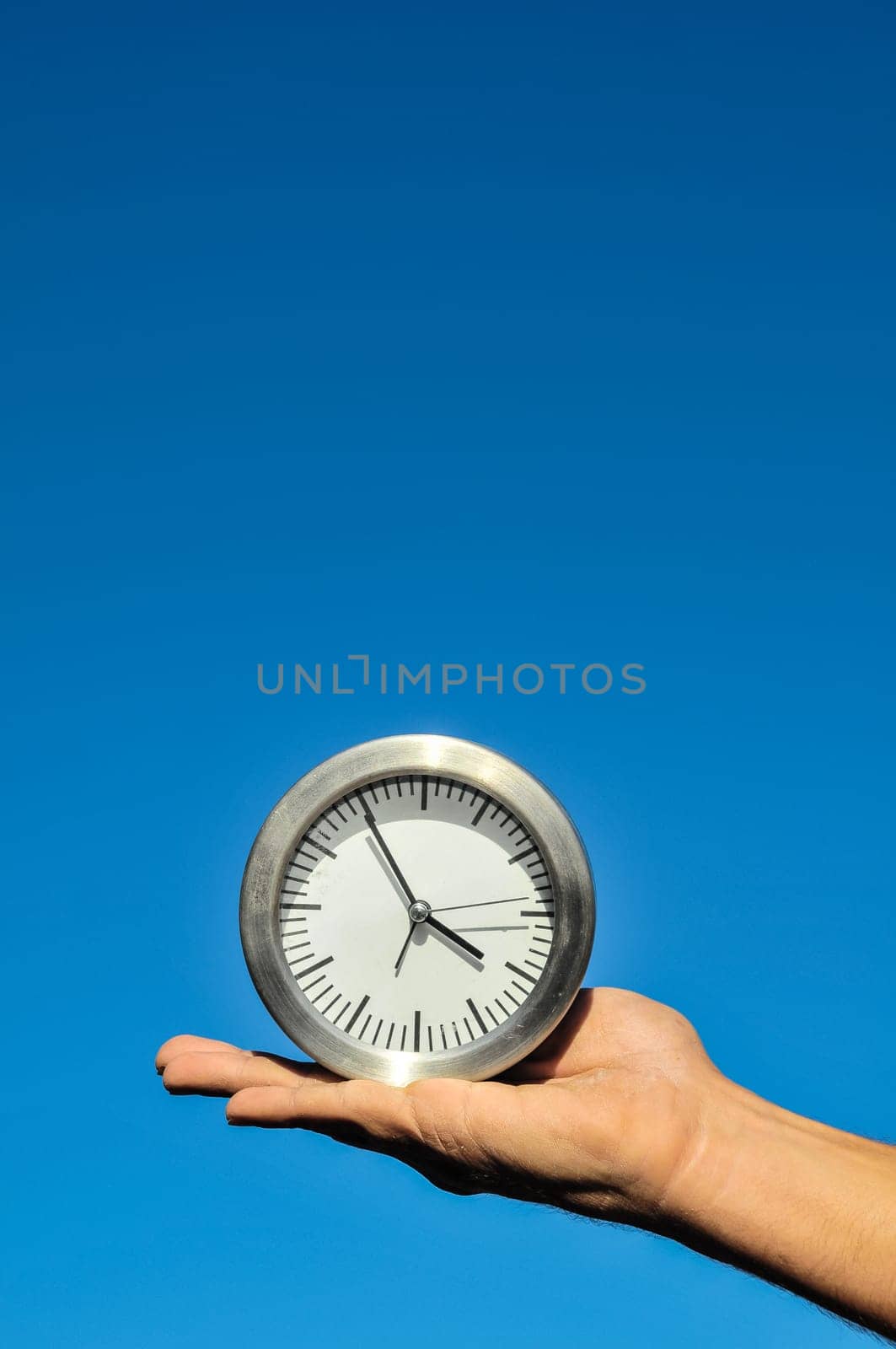 Time Concept White Sand Hourglass on the Volcanic Rocks