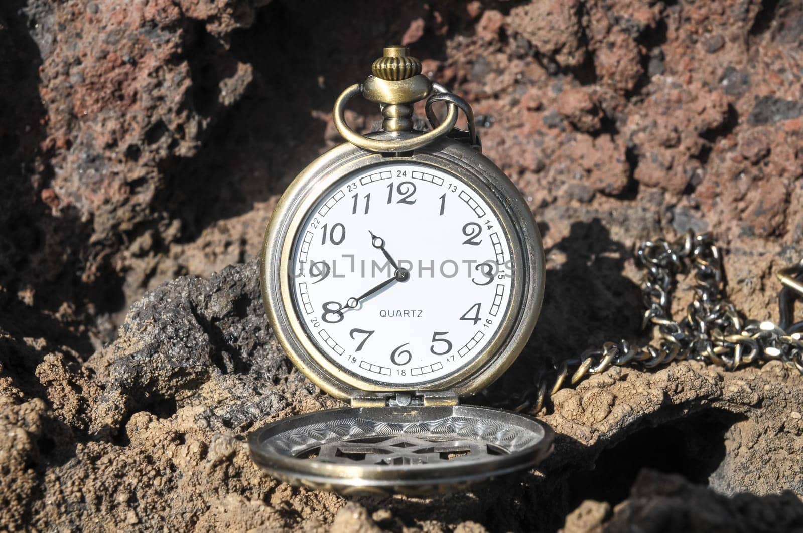 Time Concept Classic Vintage Pocket Clock on the Volcanic Rocks