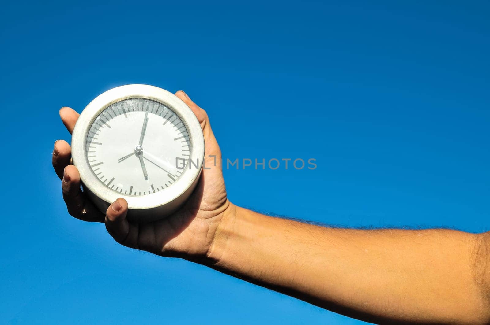 Time Concept White Sand Hourglass on the Volcanic Rocks