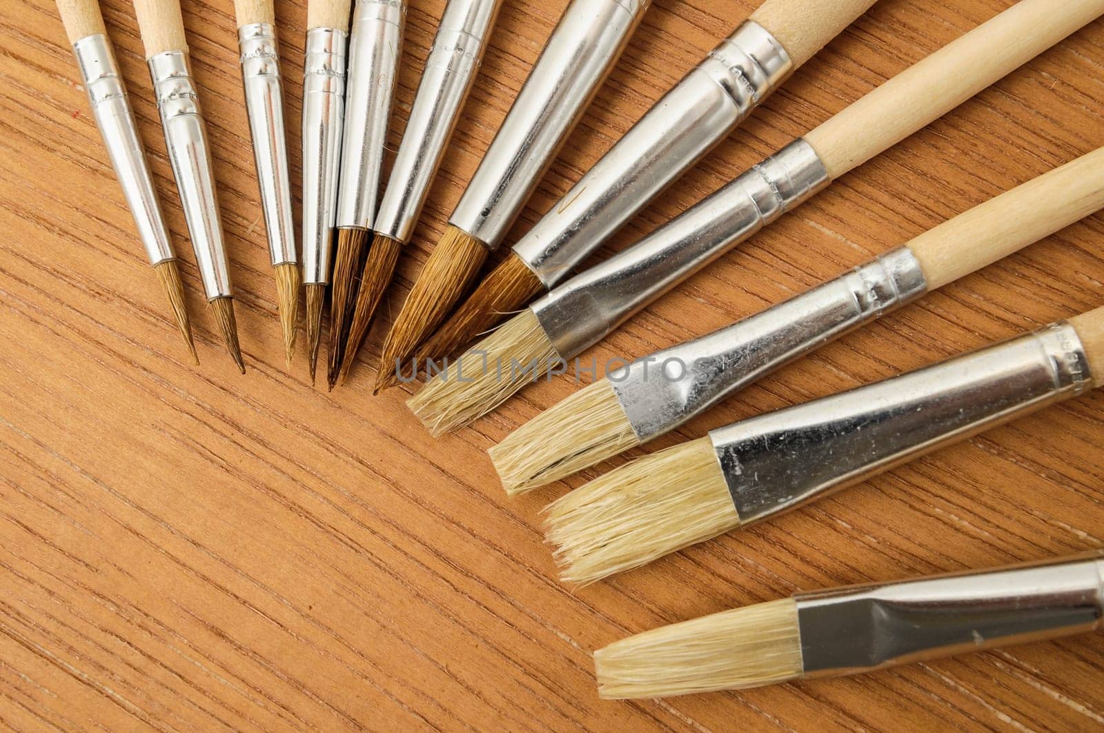 New Wooden Different Paintbrush Set Texture over a Colored Background