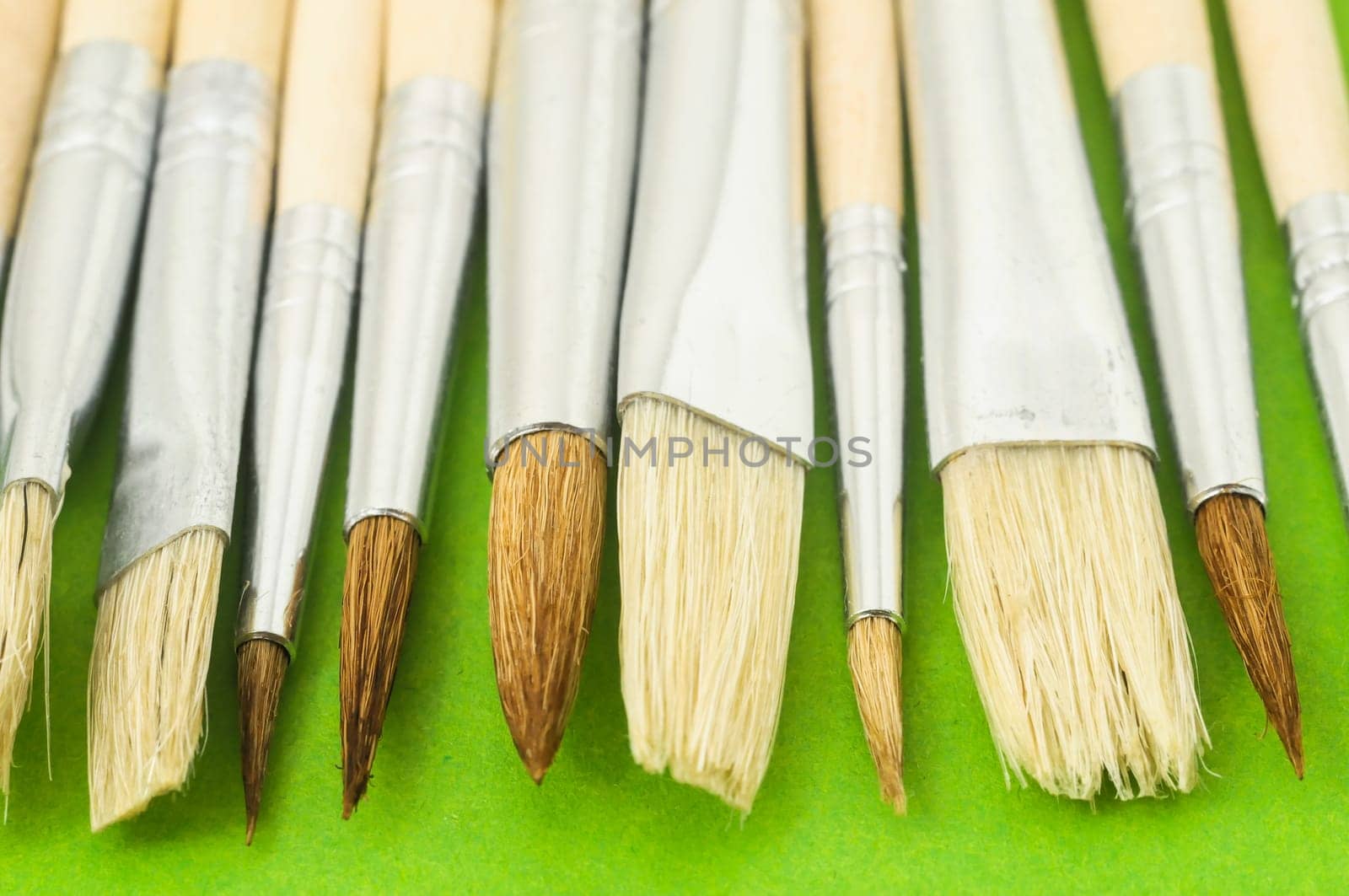 New Wooden Different Paintbrush Set Texture over a Colored Background