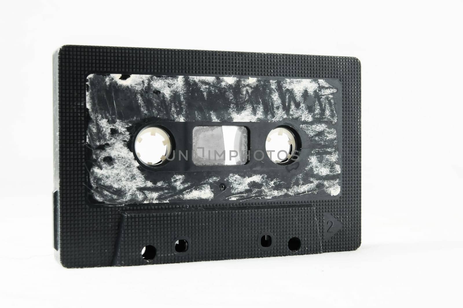 Ancient Vintage Used Musicassette over a White Background