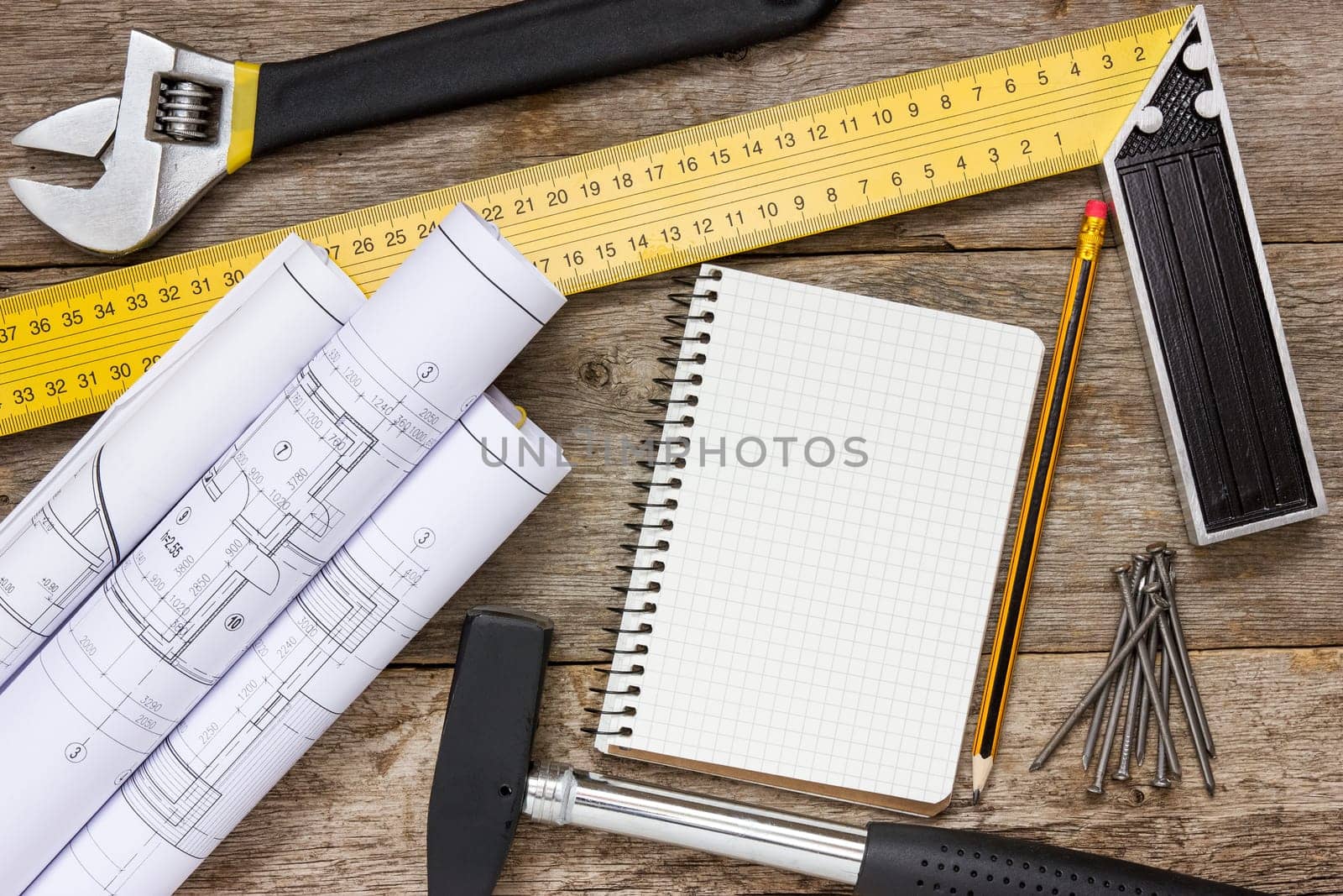 Twisted technical drawing and tools with blank notebook for your text