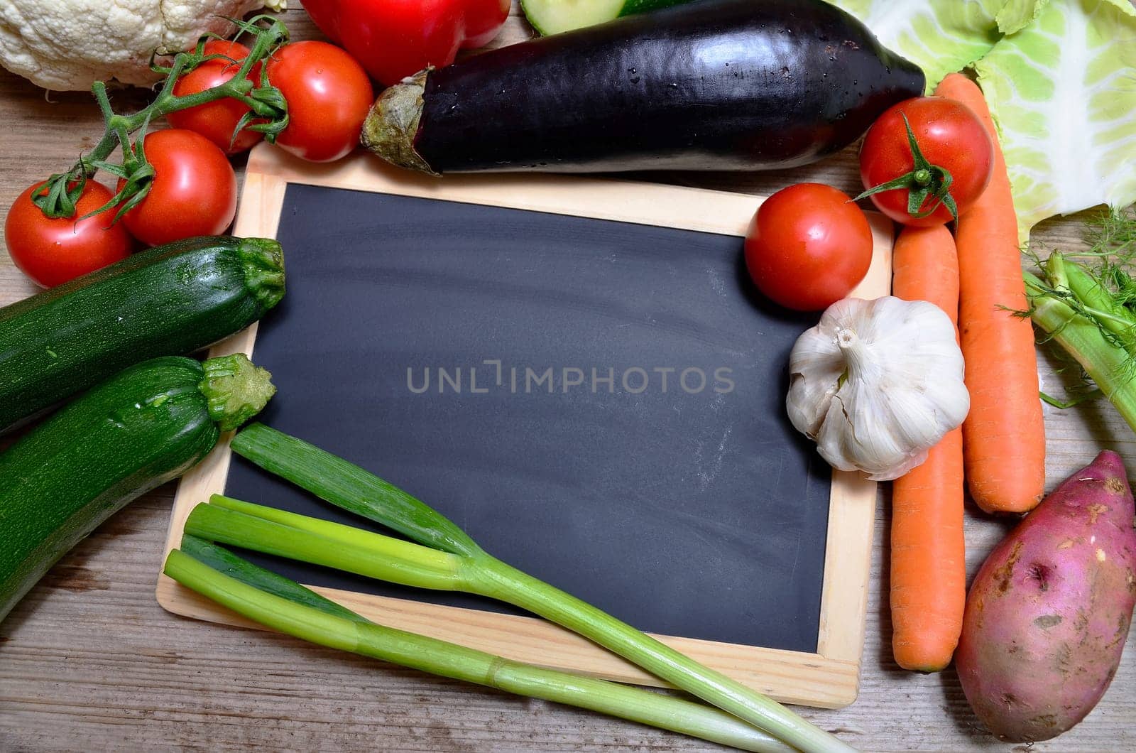 Table of fresh vegetables on wooden board