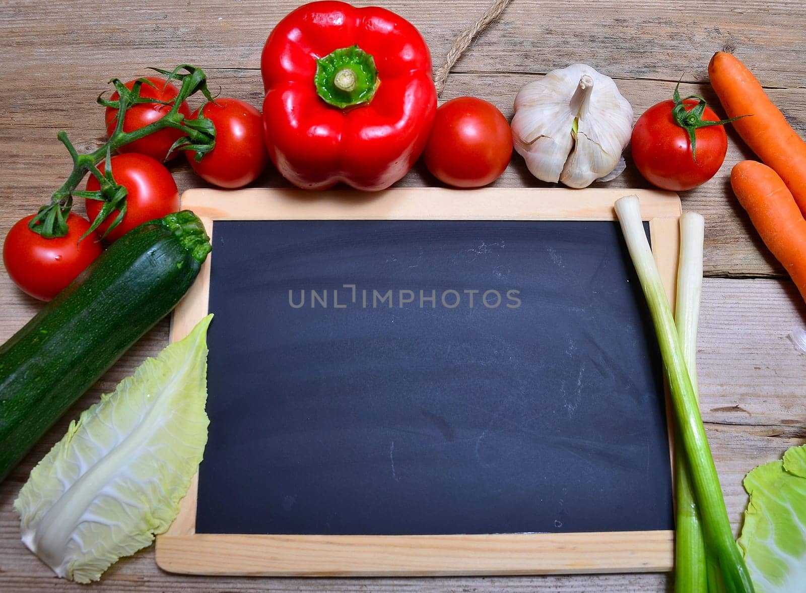 Table of fresh vegetables on wooden board