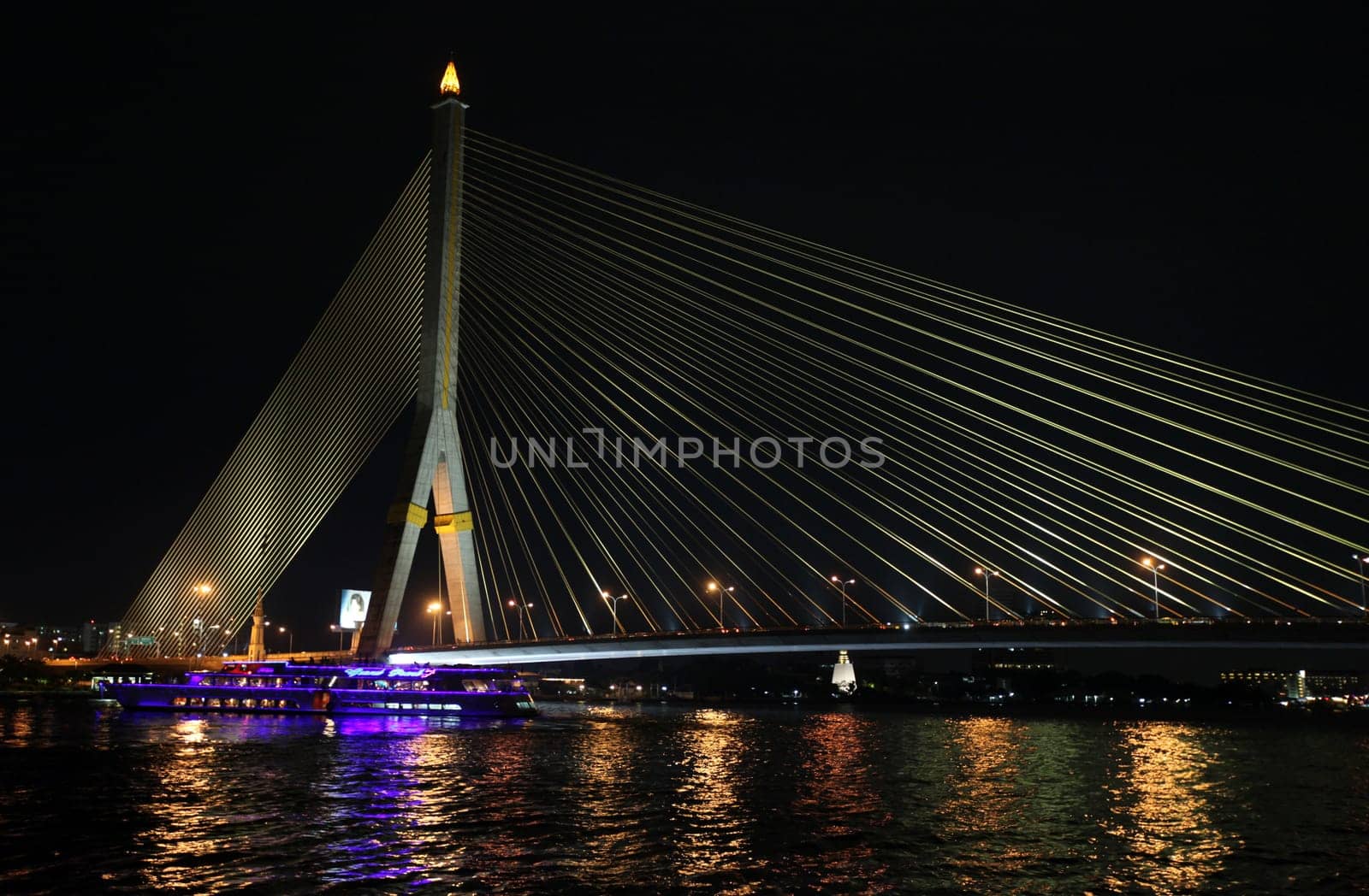 The Saphan Phra Ram 8 Brueckein the night at the Menam Chao Phraya River in the center of the capital Bangkok in Thailand.