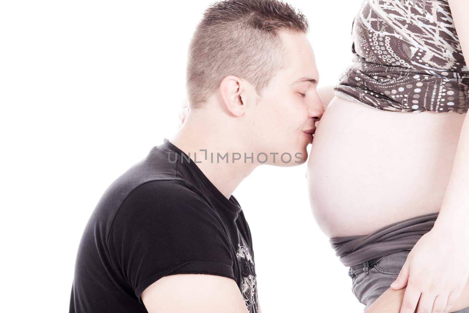 Happy young pregnant couple in the studio