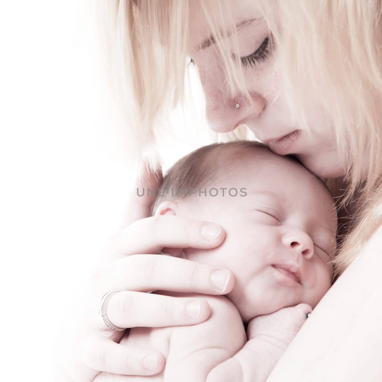 happy newborn baby girl just a week old photographed in the studio