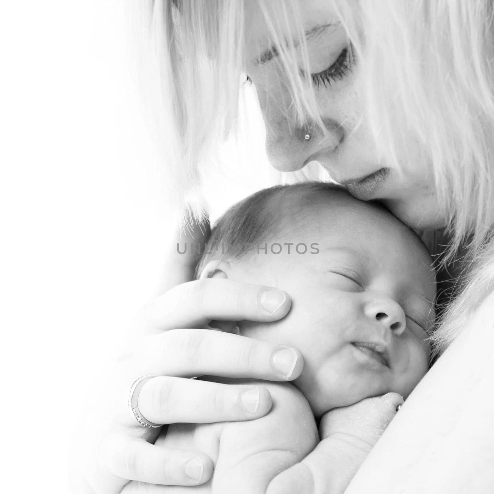 happy newborn baby girl just a week old photographed in the studio
