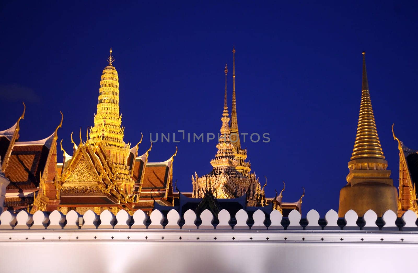 The temple gelaende in the evening atmosphere with Wat Phra Keo at the Royal Palace in the historical center of the capital Bangkok in Thailand.