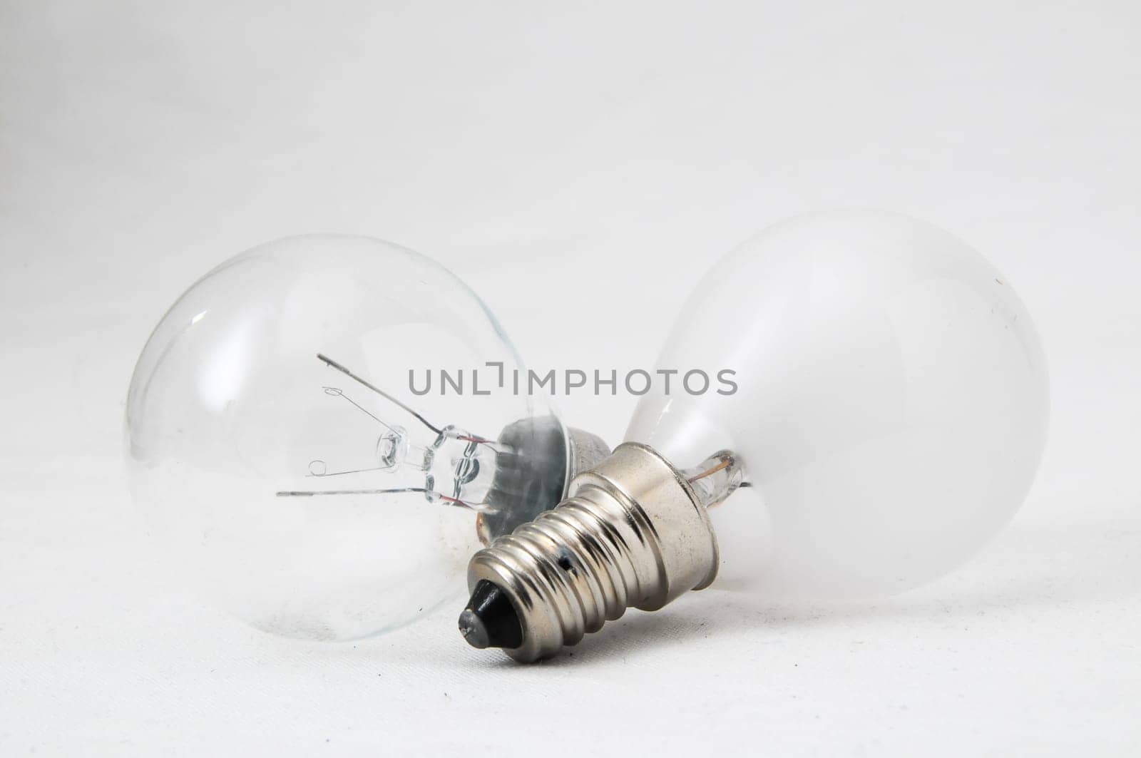 Two Different Old Incandescent Light Bulbs on a White Background