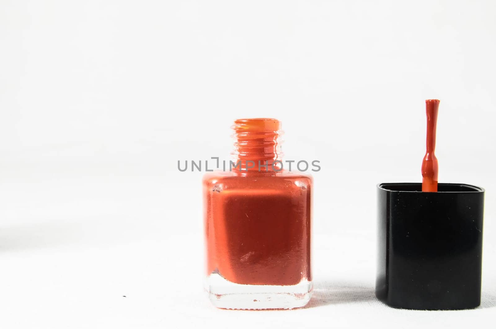 Colorful nail polish brush over white background