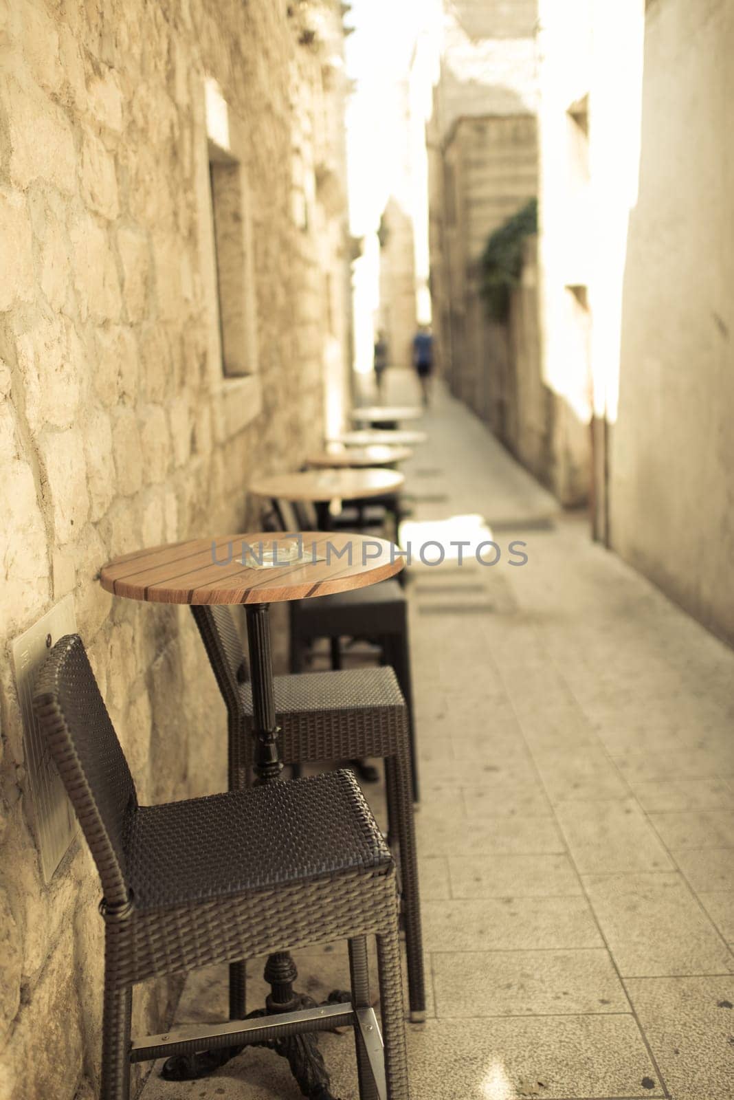 narrow street of old town with old sandstone buildings,in foreground