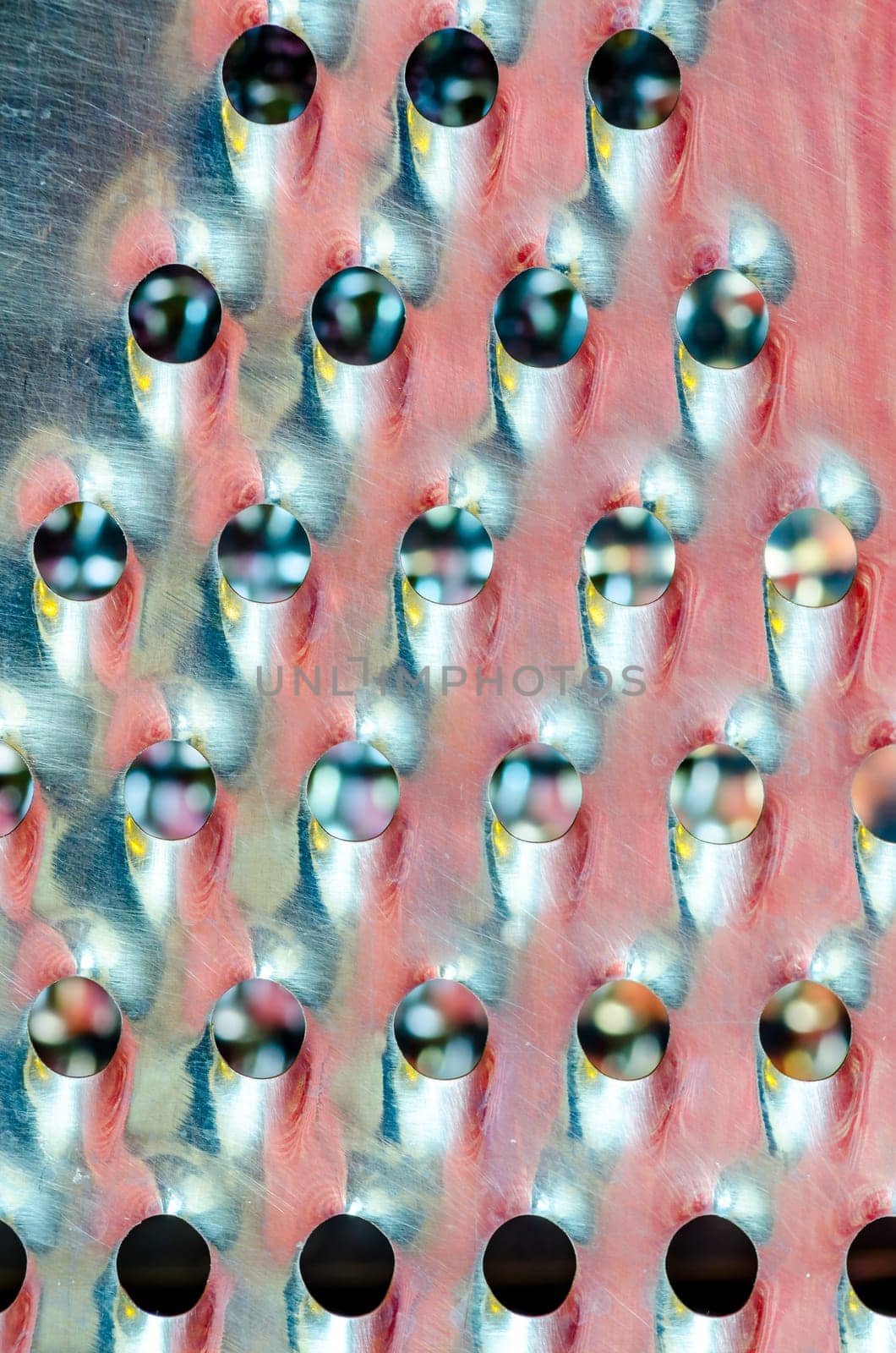 Detail close-up view of kitchen grater equipment with color reflections